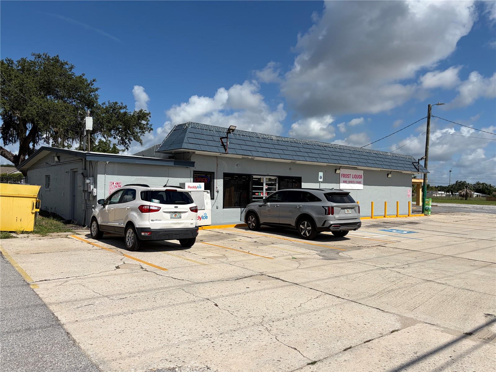 Virtually Staged. Are you looking for an amazing investment opportunity off of a busy highway in Frostproof? Come check out this 3.53 acre lot that has 3 BUILDINGS/BUSINESSES! There is a fully operating liquor store that has approximately 9 years left on escalating payment lease. It has many storage rooms and a restroom. There is also an attached building that used to be a fully functional bar/nightclub!!! It is approximately 6,700 square feet of opportunity! There is a dividing wall and it is already setup with 2 restrooms! It is currently leased with 2.5 years left on that lease but once that is complete it could be used as a cigar lounge/nightclub/bar. You will have ample parking out front for all of your customers with the oversized parking lot! There is also an open field of possibilities that is zoned commercial and can be used for more storage units, another business or additional parking. There is a 60 UNIT STORAGE BUILDING in the back of the property that has it's own separate entrance and is completely fenced. It is not air conditioned. It has 60 units 20- 10X10 units and 40- 5X10 units with 45 units currently rented with no advertisement. It has steady producing income and could grow. There is approximately 8,000 to 12,000 Average Daily Traffic Volume on the busy S Scenic Hwy (US 17) which will give you street front exposure and plenty of opportunity for business. All Measurements are approximate. Schedule your showing today!!!