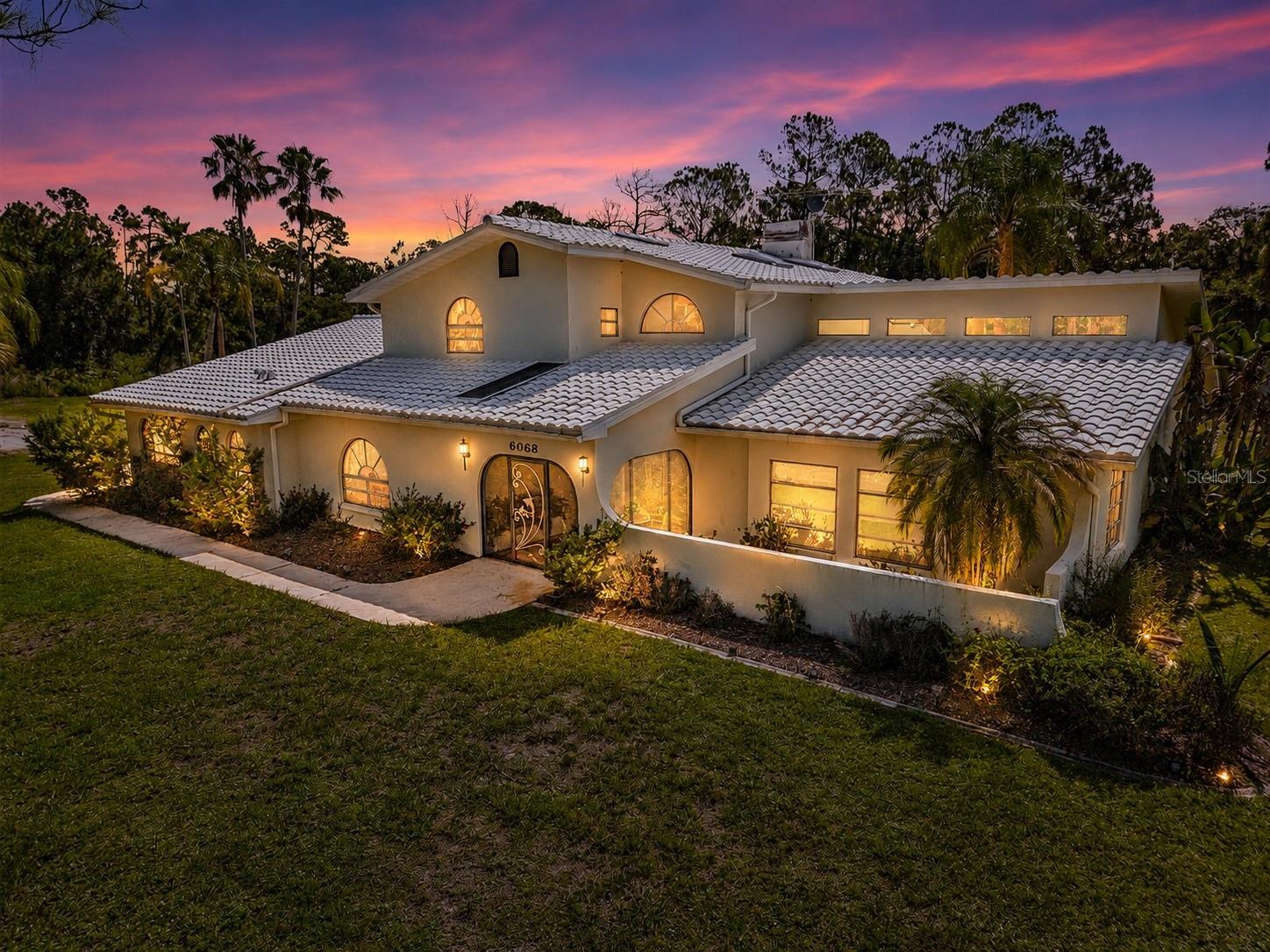 If you have been looking for privacy, usable acreage, and a home that does not feel like every other North Port listing, 6068 Tidwell Street deserves a closer look. Set on 4.66 acres in North Port Estates, this AG-zoned property gives you room for horses, gardens, a workshop, a home-based business, or simply space from the rest of the world. The home offers 3,388 sq. ft. under air, 4 bedrooms, 3 bathrooms, an office that can function as a 5th bedroom, a large screened lanai, a wood-burning fireplace, a cedar spa room, renovated primary bath, new barrel tile roof, updated electrical panel, split-zone A/C, replaced skylights, central vacuum, whole-house speaker system, and a six-zone sprinkler system. This is not a standard subdivision home. It is a private North Port Estates property with space, flexibility, and potential.