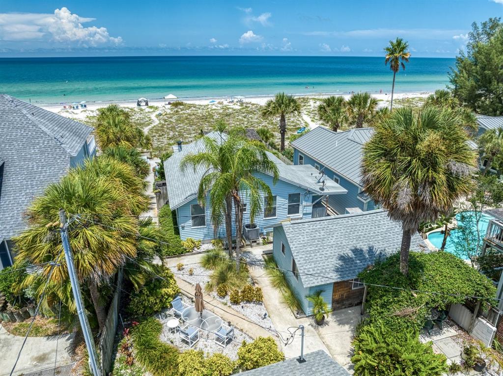 Fabulous Multi-Family Investment Opportunity in Indian Rocks Beach. This is your chance to own a 3-unit Investment/Vacation/Rental property in the heart of one of the most sought-after beach towns. Step back in time and experience Vintage Florida Charm with this
property that offers 49 feet of direct Gulf Front access. You have so many options with this turn-key property, currently grossing $200K a
year, you could rent all units, live in one, or make it your own family compound. Indian Rocks Beach allows Nightly and Weekly rentals to maximize your investment. The main house, closest to the beach, has 3 bedrooms, 2 baths, large open kitchen, spacious screened porch, and features woodburning fireplace in living room. Cottage 1 is a 1 bedroom, 1 bath with kitchen, dining and living room. Cottage 2 is a studio with a kitchen, living and private bath. All units are individually metered and come equipped with attractive furnishings and ample parking for guests in front of the property. Walking through the palm trees into the tropical oasis, there are many shared areas for guest to gather. The large Tiki Hut has a grilling area and plenty of places to soak up the sun. There is a full-sized washer/ dryer and outdoor showers. Indian Rocks Beach is golf-cart friendly, multiple parks, beach art center, library, great restaurants, and local shopping all within walking distance. For an instant and true walk-through experience, be sure to view the virtual tour, floor plans and Matterport tour. Whatever your investment goals are, IRB is an outstanding beach community to invest in! We ask that you please respect tenant privacy and do not walk the property without an appointment.
