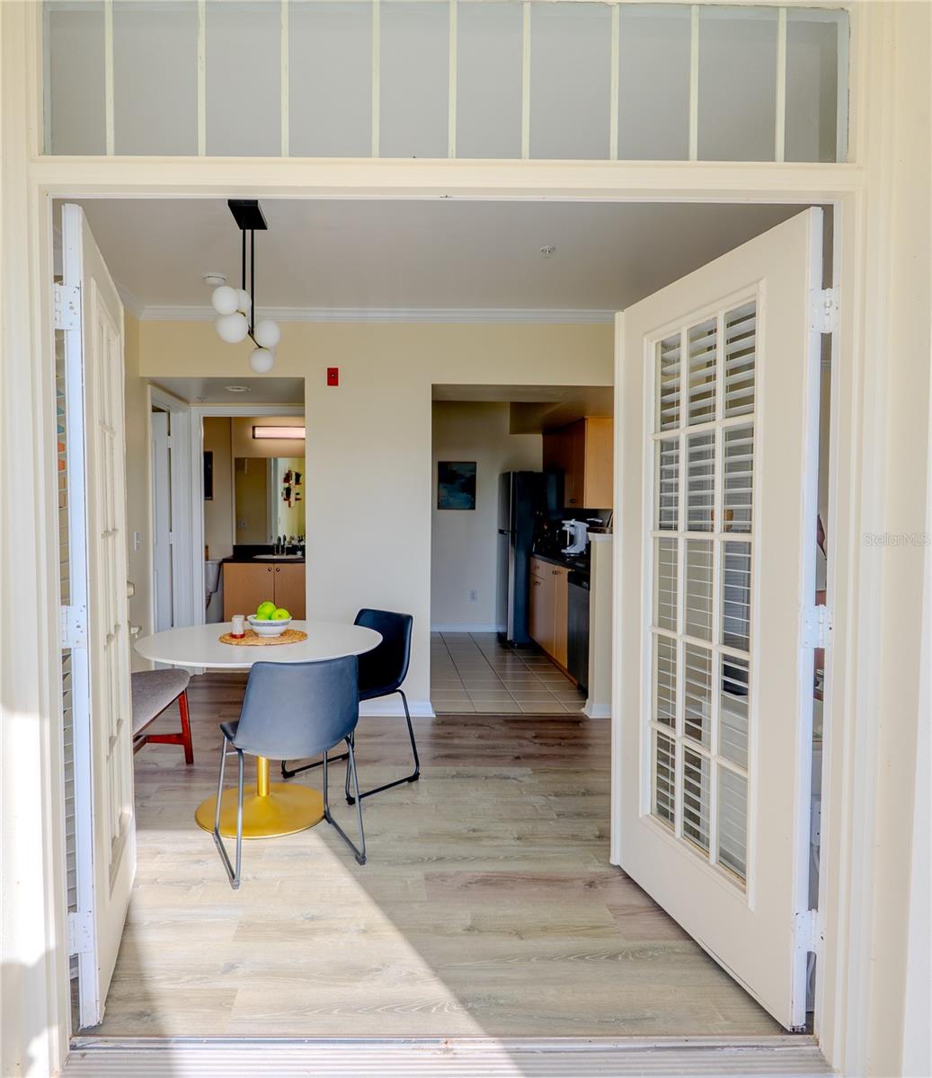 Experience a serene water conservation view from the living room, or bedroom, and through elegant French doors in this beautifully maintained 1-bedroom, 1-bath condo in the highly sought-after Siena at Celebration community. Ideally located in the heart of town, this home features expansive front windows and French doors that flood the living and dining areas with natural light, creating a bright, airy atmosphere and a seamless calm connection to the outdoors. The open-concept layout features luxury vinyl flooring throughout the main living spaces, complemented by crown molding for a refined finish. The spacious primary bedroom includes a large walk-in closet, while a dedicated laundry room with a full-size stacked washer and dryer adds both convenience and extra storage. Recent updates provide added value and peace of mind, including new blinds (2023), toilet (2024), dishwasher (2025), and a new ceiling fan in the primary bedroom (2025). Residents of Siena enjoy resort-style amenities, including Siena's clubhouse, pool, fitness center, and playground—plus access to all Celebration has multiple community pools, tennis and basketball courts, sand volleyball, and over 26 miles of scenic walking and biking trails, along with charming shops and dining. Ideally located just minutes from Walt Disney World and Orlando International Airport, this home has the perfect blend of tranquility and convenience. Condo fees are projected to decrease in 2026. The unit is vacant, easy to show, and the seller is open to buyer concessions. This could be your home, schedule a showing today!