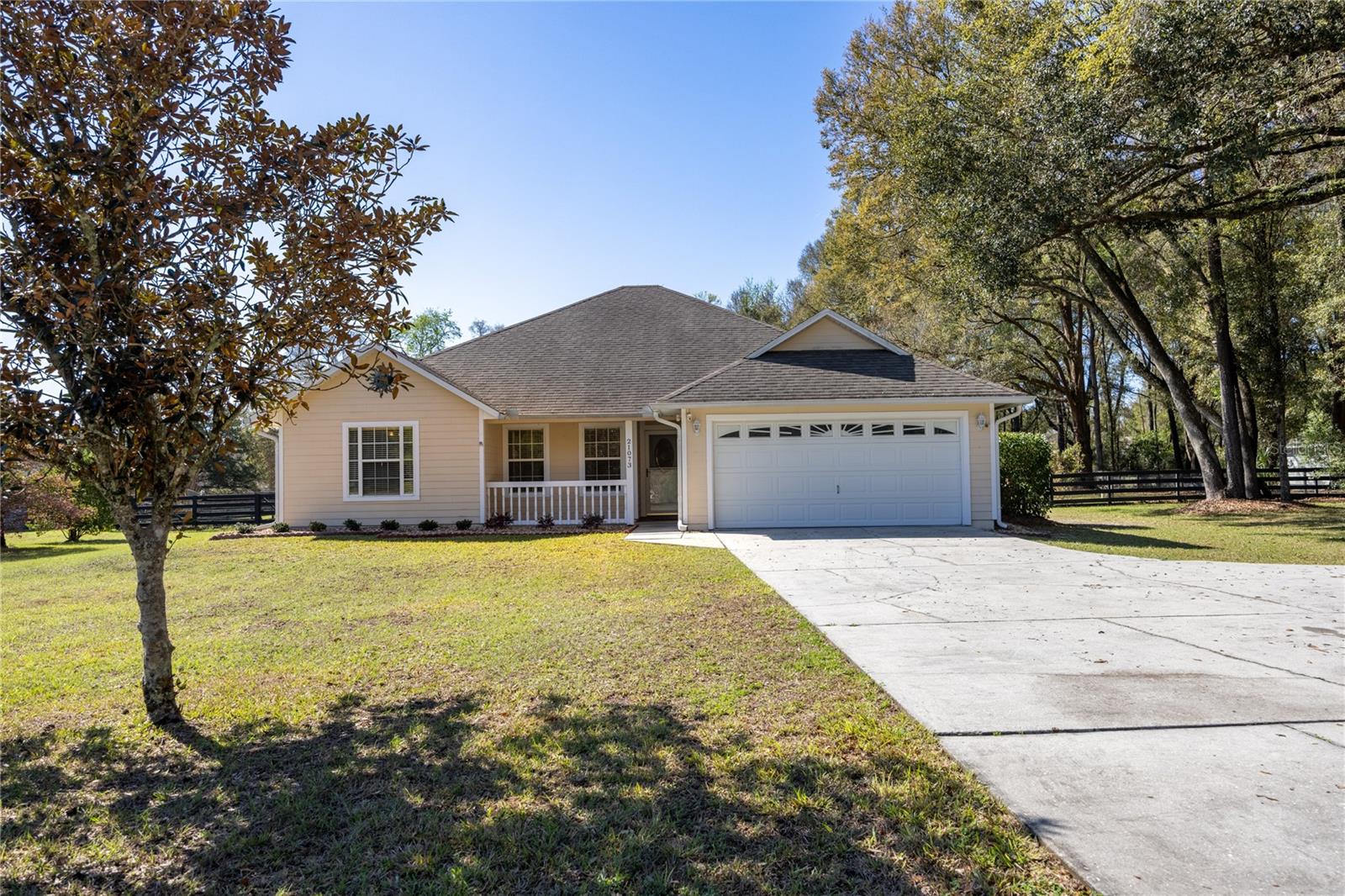 Located on a spacious fenced 1-acre lot in the Edgemoor subdivision of High Springs, this well-maintained 4-bedroom, 2-bath home offers approximately 2,160 square feet with an open, split floor plan designed for comfortable living. The large great room features vaulted ceilings and a wood-burning fireplace, creating a warm and inviting gathering space that flows into the dining area and kitchen. Interior has been freshly painted throughout.

The kitchen overlooks the main living areas and includes all appliances, including a French door refrigerator, dishwasher, microwave, and oven/range, along with abundant cabinetry, a pantry, and plenty of counter space. The primary suite features two walk-in closets and an ensuite bathroom with dual vanities, a soaking tub, and a large walk-in shower. Three additional bedrooms and a full bathroom are located on the opposite side of the home, providing a functional and flexible layout.

Interior flooring includes laminate in the living room, ceramic tile in the kitchen, dining area, hallway, laundry room, and bathrooms, and wood-look tile in the primary bedroom. The home also includes an indoor laundry room with washer and dryer included. Major updates completed in 2020 include the roof, HVAC system, hot water heater, kitchen appliances, and a mini-split system that services the enclosed rear porch, providing additional climate-controlled space. 

Outdoor features include mature trees and landscaping, a fully fenced yard, a workshop, an RV hookup with additional fenced storage space. The neighborhood features winding roads and a local park within walking distance. Conveniently located between High Springs and Alachua with easy access to US 441, the property is approximately 20 minutes from Gainesville and Lake City.