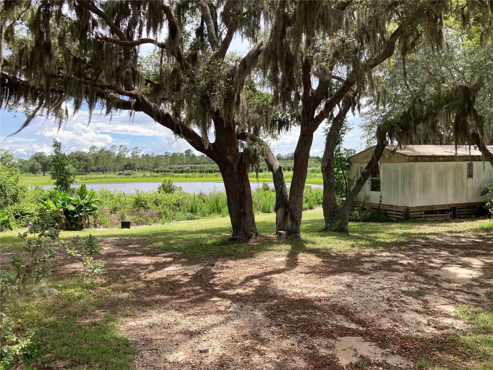 Discover the possibilities with this unique 4.2-acre property in the heart of Clermont, Florida. Featuring an irregular-shaped parcel with beautiful water views, this property offers the perfect opportunity to create your own private country retreat while still enjoying convenient access to shopping, dining, and major roadways.The property includes a pre-1977 manufactured home that can serve as a temporary residence, rental opportunity, or be removed to make way for your dream home. A dedicated ¼-acre homesite, surrounded by mature trees, provides an ideal setting for future construction, offering privacy, shade, and a picturesque backdrop. A new well will be needed, allowing the new owner to customize the property's utility improvements to suit their plans. Whether you're looking for space to spread out, room for recreational vehicles and toys, or the opportunity to build in a peaceful setting with scenic water views, this versatile property offers endless potential. Enjoy the beauty of rural living while remaining just minutes from all that Clermont has to offer. Opportunities like this are becoming increasingly difficult to find—bring your vision and make this exceptional property your own. *Owner Financing Available*