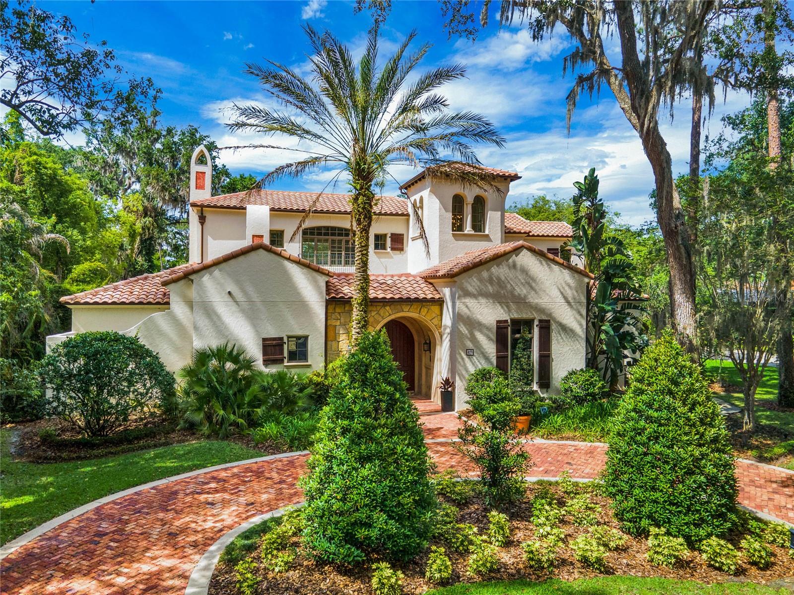 Serene and private estate on a half acre lot in the Heart of Olde Winter Park. A custom built estate with amazing detail throughout boasts 6 bedrooms (downstairs master plus a first floor mother in law suite), 6 bathrooms, 3 half baths, an elevator for easy 2nd floor access, 2 living areas, all with terrific views of your private oasis of a backyard, beautiful pool & spa. Groin Vaulted ceilings that have been hand painted with detail throughout the home, both upstairs and down. New wood floor sprawl through the first floor making this estate feel cozy and warm. As you enter through the oversized arched wood front doors, a brick patio sitting area with a gas fireplace awaits.  From this private courtyard, you then enter into the grand living room that greets you with views of the private backyard, pool, a second outdoor fireplace, summer kitchen, plenty of covered patio living areas, a turfed dog run and a sunbathing landing near the sap. The kitchen is a chef's dream with amazing custom cabinets, stone counter tops, Wolf gas range with 6 burners, griddle and grill, a beautiful custom stone vent hood, built in cabinet paneled sub zero refrigerator and freezers with drawers, warming drawer, two dishwasher drawers plus a full dishwasher, a built in microwave and TWO walk in pantries. A private door leads you to the Scullery, a private room for dirty dishes, laundry and storage while entertaining. Your caterers will not be seen while entertaining! The dinette off the kitchen flows into the family room boasting a beautiful fireplace with built ins and plenty of storage, of course all with a view of your private oasis of a backyard. Sliding doors off the family room open up to a large covered porch area where you have room for an outdoor dining and living room. Off the other side of the kitchen, is a 1000 bottle climate controlled wine room with its own serving area. The dining room has beautiful hand painted ceilings with french doors leading out to an additional covered patio. The primary bedroom is oversized, plenty of natural light over looking the private backyard, and hand painted coffered ceilings. The primary closet and bathroom are overly generous with a bank of built-ins plus a walk in closet with a 3rd laundry option. The impressive bathroom features a jetted tub, double entry walk in shower with multiple heads, plenty of countertop space, private water closet with bidet, and a private outdoor shower.  The mother in law suite and office or 6th bedroom are also on the first floor. On the second floor there is an additional laundry room, 3 more bedrooms with en suite bathrooms and walk in closets, an amazing media and movie room PLUS a loft and an additional game room. There is a landing area at the top of the stairs that could be used as a homework station, sitting area or reading nook. The game room does have an en suite bathroom and closets if someone preferred an upstairs master but it is not counted in the bedroom count. The game room offers a serving area with a sink and beverage refrigerator with ice. There is a covered porch off the game room with views of the pool area and private backyard. WOW your own movie theatre!! The equipment is in place and the theatre seats 10 in over sized theatre chairs. The home offers a whole house generator, central vacuum system, elevator, natural gas, a 3 car garage and amazing night lighting. Beautiful brick and travertine paved walk ways adorn the front yard with the mature landscaping. Room Feature: Linen Closet In Bath (Primary Bathroom).
