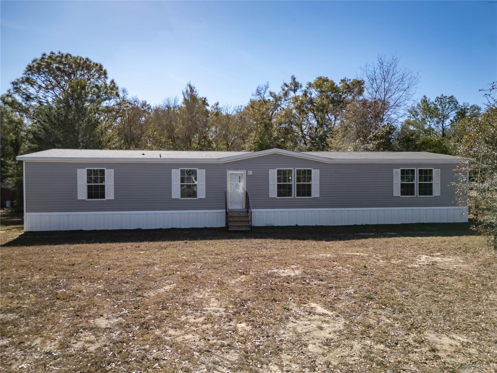 Move-in ready and never lived in! This 2022-built 5-bedroom, 3-bath mobile home sits on a spacious 1.25-acre lot in Levy County, offering the perfect blend of modern comfort and peaceful country living. With an open floor plan, generous bedrooms, and plenty of space both inside and out, this home is ready for its first owner. Enjoy privacy, room to roam, and the freedom of acreage living—all just waiting for you to make it your own. This is perfect for anyone looking for room to grow in the country.