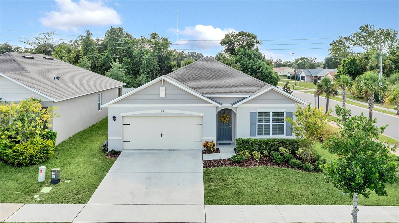 **IMPROVED PRICE**   Why wait to build new?  Here’s your like-new, (2020) ever popular CALI model - right NOW available and very affordable!  This beautiful, 4 BEDROOM, 2 BATH HOME has the stunning open floor plan that the CALI is so well-known for:  the SPARKLING KITCHEN, with a HUGE  BREAKFAST-BAR ISLAND, OPEN DINING ROOM, and SPACIOUS FAMILY ROOM COMBO.  The SPLIT BEDROOM plan gives PRIVACY TO THE OWNERS' BEDROOM SUITE, separated from the other 3 bedrooms.   Bring all your extra shoes and clothes, this owners’ suite has 2 SEPARATE LARGE WALK-IN CLOSETS with storage space galore!   The inside utility room is conveniently located off the foyer, with the WASHER AND DRYER INCLUDED!  Located on a GORGEOUS LANDSCAPED CORNER LOT, with NO REAR NEIGHBORS!  AND – LUCKY YOU - it comes with a NEWER VINYL FENCE, and SCREENED-IN LANAI, AND a beautiful EXPANSIVE, PAVED PATIO AREA, making your cookouts and outdoor entertaining even more pleasant.   Energy efficient a/c and windows throughout.  Located in the heart of flourishing Orange City, the premier Community of PARC HILL offers a huge community pool, playground, with active/walking areas, and numerous dining and shopping spots,  and schools nearby.   Call today so you can call this beautiful home YOURS!