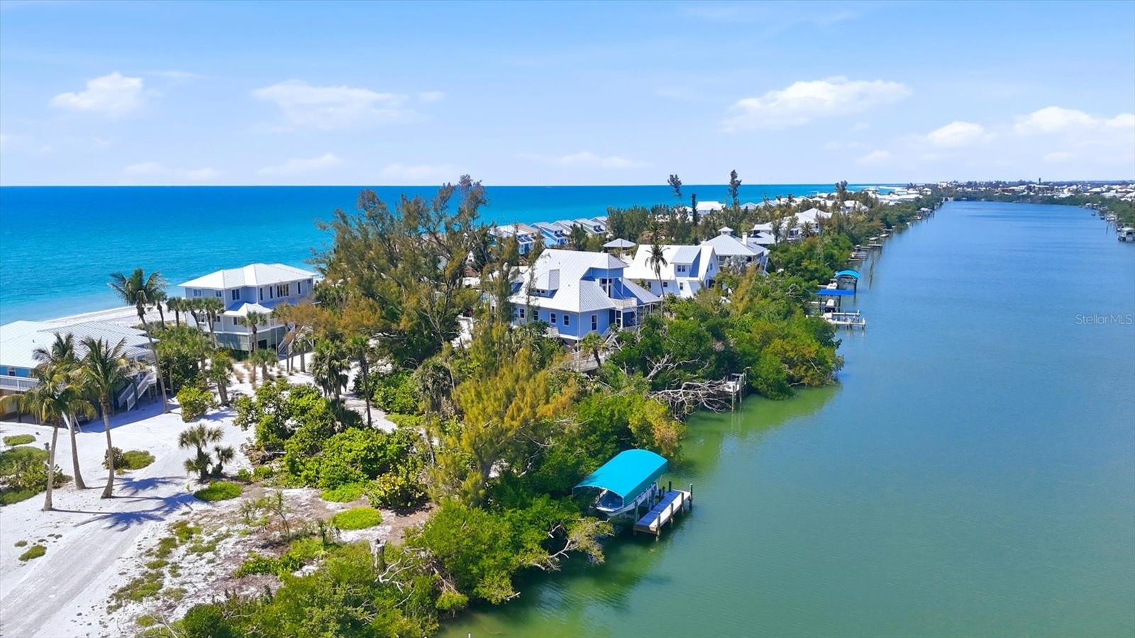 STUNNING GULF-TO-BAY ISLAND ESTATE in the exclusive, gated community of Bocilla Beach to Bay on Don Pedro Island. Situated on ¾ of an acre with over 130 feet of direct beachfront, this rare property offers unmatched privacy, framed by lush tropical landscaping and the serene beauty of the Gulf.

Designed for the ultimate coastal lifestyle, the property includes a private deeded dock with a 10,000 lb covered boat lift and even comes complete with a 24' Boston Whaler Dauntless—ready for days on the water. Offered turnkey furnished, this home also includes a new golf cart, making island living effortless from the moment you arrive.

The residence features 4 bedrooms, 3.5 baths, plus an upstairs office showcasing a wall of windows with sweeping views of the turquoise Gulf waters. A 3-stop elevator services all levels, leading to an upper floor where the primary suite—and a potential second primary—overlook the quiet, pristine beach.

The main living area is bright and inviting, with new hurricane-rated sliding glass doors opening to a spacious screened lanai, allowing coastal breezes to flow throughout. Downstairs, a massive shaded deck creates the perfect space for year-round outdoor living and entertaining.

Additional highlights include a newer metal roof, new A/C system, hurricane shutters, golf cart garage, and abundant storage.

Bocilla Beach to Bay offers an ultra-private island lifestyle with amenities including a community pool, tennis courts, and a golf cart bridge. This is a rare opportunity to own a true Gulf-to-Bay estate where boating, beachcombing, and breathtaking sunsets are part of everyday life.