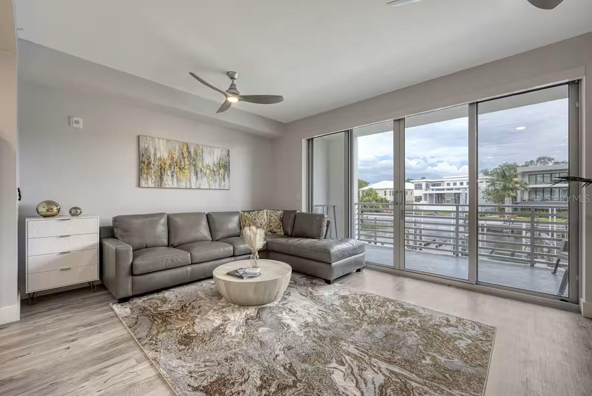 Discover the perfect blend of sophistication and relaxation in this one-bedroom plus den condo at The Strand, a premier waterfront community. Built in 2022, this turnkey furnished residence showcases over $20,000 in designer décor, offering an immediate sense of style and comfort. With breathtaking views of Sarasota Bay, this condo is ideal for full-time living, a vacation retreat, or a lucrative weekly rental investment. 
Inside, the open layout boasts luxury vinyl flooring, quartz countertops, sleek modern cabinetry, and stainless-steel appliances. Beyond the condo, The Strand offers exceptional amenities, including a resort-style heated pool and spa, a fitness center, a dog park, and a floating kayak dock that leads to the Gulf of Mexico. EV charging stations, a fire pit, and gas grills add to the convenience. 
Situated just a mile from downtown Sarasota, this property places you within easy reach of top-notch restaurants, cultural venues, and vibrant events like the Saturday farmers market. Nearby attractions include St. Armands Circle, Lido Beach, and the award-winning Siesta Key Beach. With an assigned parking spot, extra storage, and access to Sarasota’s best, this condo is your gateway to a luxurious waterfront lifestyle. Incredible property for a primary home, a vacation home or to be used as an investment. The unit can be rented 52 times per year min 7 days. Schedule your private tour today and experience The Strand!