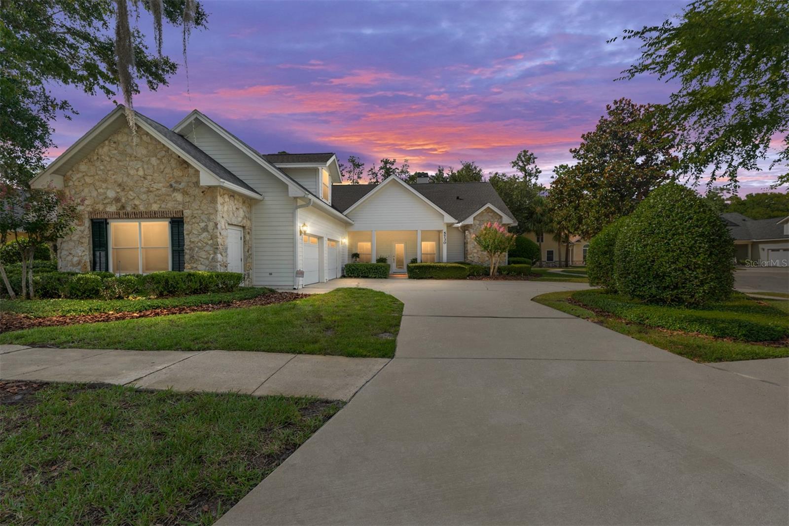 Graceful architecture, generous proportions, and exceptional privacy define this beautifully maintained four-bedroom home, ideally situated within the gated community of Millhopper Forest. Perfectly positioned on a private lot backing to protected green space with no future development planned beyond the property, the setting offers a rare sense of tranquility. Just beyond the entry, a distinguished library-inspired office immediately establishes the home's timeless character. Framed by French doors, floor-to-ceiling built-in bookcases, and classic interior shutters, the space is equally suited for focused work, quiet reading, or creative pursuits. Rich engineered wood plank flooring continues into the formal dining room, where an elegant chandelier creates an inviting setting for memorable gatherings. From there, the home unfolds naturally into the welcoming living room, anchored by a beautiful corner fireplace and seamlessly connected to the kitchen for effortless entertaining. White cabinetry, abundant storage, and a convenient connection to the dining room make the kitchen both functional and inviting, while the adjoining breakfast nook provides a comfortable space for everyday meals. Whether hosting celebrations or enjoying an unhurried morning coffee, these thoughtfully designed gathering spaces encourage connection and conversation. The expansive primary suite offers room to truly unwind, complemented by dual walk-in closets and a spacious five-piece bath that blends classic design with generous storage. Two secondary bedrooms share a Jack-and-Jill bath, while an upper-level guest suite provides the comfort and privacy of its own en suite bath. A thoughtfully designed laundry and mud room with built-in cabinetry and a utility sink adds everyday practicality without sacrificing style. Outside, the covered lanai creates a shaded extension of the living space overlooking a large, level backyard with endless possibilities for entertaining, gardening, recreation, or peaceful evenings outdoors. A whole-home central vacuum system, water softener, and attached two-car garage with a dedicated workshop area further enhance the home's thoughtful design and functionality. Combining timeless craftsmanship, practical updates, and an exceptionally private setting within one of Gainesville's most established gated communities, this is a rare opportunity to enjoy both everyday comfort and enduring quality.