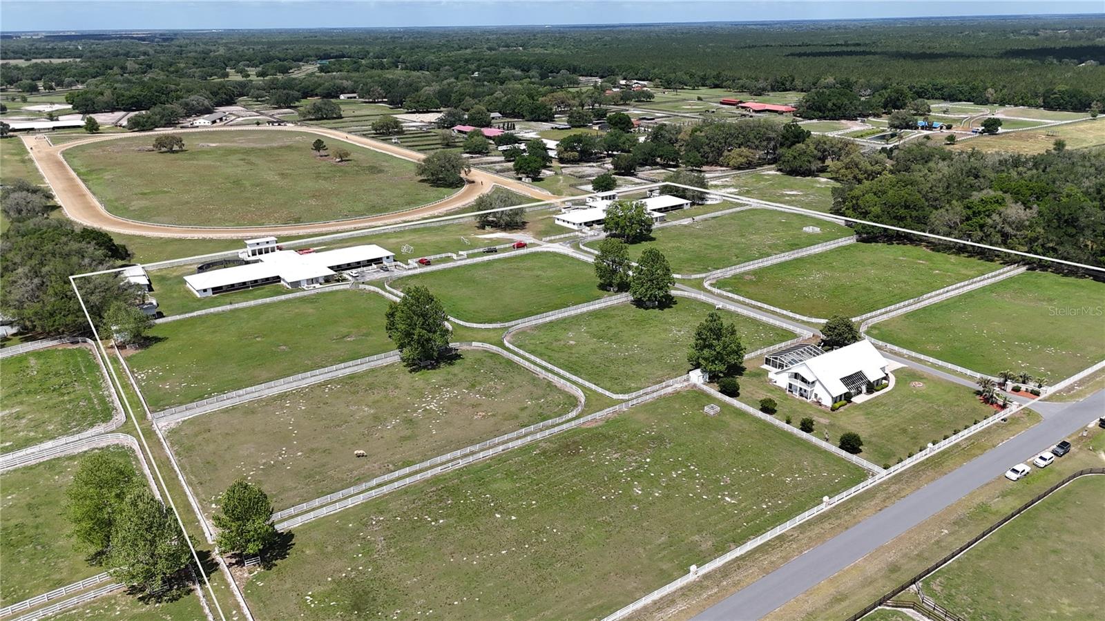 Located within the highly regarded Starting Point Training Complex, this 17-acre, high-capacity equestrian facility is designed for serious training operations, offering exceptional footing and a highly functional layout that prioritizes efficiency, safety, and flow.  This property is built to handle volume while maintaining a professional standard.
The infrastructure supports immediate operation with significant stall count and flexibility across multiple barns, including a 42-stall, 36-stall, 8-stall, and two 3-stall barns, ideal for accommodating multiple training programs or disciplines
The farm is fully equipped with two Eurocizers, two round pens, and 10 paddocks, all fenced, cross-fenced, and serviced with water, allowing for organized turnout and conditioning. 
Deeded access to a 5/8-mile irrigated track with a starting gate, viewing stand, and riding trails offering a major cost and logistical benefit for consistent, year-round conditioning without the overhead of private track maintenance.
Residential components add further value, including a 5-bedroom main home with pool and an updated 3-bedroom, 2-bath apartment, perfect for on-site management, staff housing, or additional income potential.
Strategically located under 6 miles to HITS and less than 15 miles to the World Equestrian Center, with direct access to Ocala’s equine services and supply network, this property is positioned for both operational success and long-term value.

Please note: Only 17 acres of the 40 acres reflected in the property appraiser records are included in this offering.