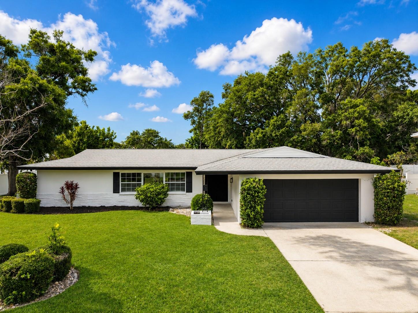 Virtually Staged. Completely renovated 4-bedroom, 3-bath home in sought-after Harbor Bluffs! This move-in-ready residence features a new central air system, roof replaced in 2020, and updated plumbing in 2023. Inside you'll find luxury wood-look tile flooring throughout, a stunning designer kitchen with shaker cabinetry, quartz countertops, stainless steel appliances, and an abundance of storage. The spacious open floor plan is highlighted by a dramatic accent wall and large living areas ideal for entertaining. A standout feature is the oversized custom mudroom/laundry room with built-in cabinetry, bench seating, utility sink, extensive counter space, and room for full-size washer and dryer. Renovated bathrooms feature modern vanities and fixtures, while the spacious primary suite offers a private retreat. Conveniently located near Gulf beaches, shopping, dining, parks, and top-rated amenities.