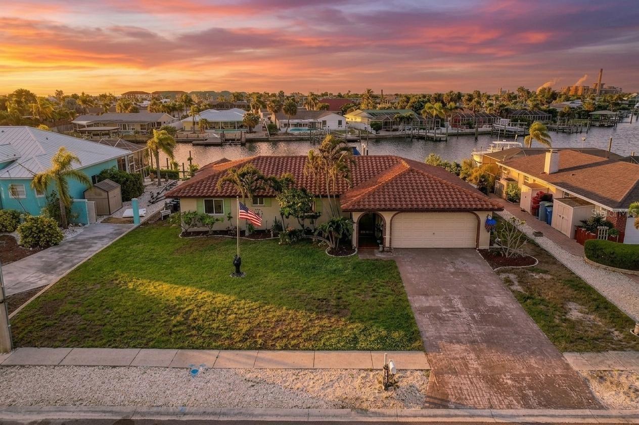 APOLLO BEACH WATERFRONT with DIRECT TAMPA BAY ACCESS! Rare opportunity to own a deep-water canal home with 73 feet of waterfront on a wide canal with no bridges and no restrictions — truly sailboat and yacht friendly! Located in one of Apollo Beach’s most desirable boating communities with NO HOA and NO CDD, this property offers the ultimate Florida waterfront lifestyle.

HIGH & DRY — this home experienced ZERO flood damage during both recent hurricanes, with no flood insurance claims and no FEMA assistance. Built in 1981 by highly respected local builder Apple Homes, known for quality waterfront construction throughout Tampa Bay, this solid-built home has had only two owners. Completely remodeled approximately four years ago with both luxury and longevity in mind. This solid-built home features cedar stud construction, a tile roof, hurricane-impact windows installed in 2021, new A/C, and an updated seawall for added peace of mind.

Boaters will appreciate the new premium composite dock and 20,000 lb. boat lift complete with water and electric, providing immediate access to Tampa Bay and Gulf waters. Spend your days fishing from your dock, cruising at sunset, or enjoying Apollo Beach’s famous holiday boat parades right from your backyard.

Step inside to a beautifully renovated open-concept layout designed for modern living and entertaining. The chef’s kitchen is the centerpiece of the home, featuring quartz countertops, solid wood shaker cabinetry, stainless steel appliances, a farmhouse sink, designer range hood, stunning glass tile backsplash, and a spacious kitchen island complete with breakfast bar seating. Luxury vinyl plank flooring runs throughout the home, complemented by updated lighting and ceiling fans throughout. The spacious primary suite offers a newly renovated ensuite bath with updated vanity and a walk-in shower finished with designer tile.

Outdoor living is just as impressive with a screened lanai, sunken above-ground pool, and an air-conditioned backyard shed/workshop perfect for hobbies, storage, or workspace needs.

Move-in ready and built for the waterfront lifestyle, this is a rare opportunity to own a storm-tested Apollo Beach canal home offering deep water access, modern updates, and unbeatable boating convenience!