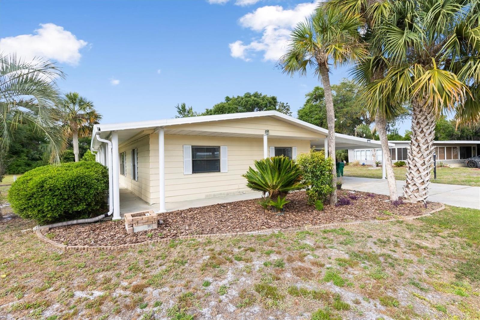 Across the street from the "Villages Brownwood Square" for nightly entertainment, dining and shopping. Own the home and the land in this remodeled 3 large bedrooms and 2 1/2 bath remodeled home. The main part of the home is 70 x 24 (1680 sq. ft.) under heat and air conditioning, with an attached additional 18.6 x 20.2 Florida room, 11.3 x 9.4 laundry room, 13.11 x 11.3 workshop. Making total sq. ft approx. 2300 sq. ft.  New Laminate flooring and freshly painted home also offers a large family room. The large carport can cover 2 cars. The roof is 2014 and the HVAC is 2012, the HVAC has a new blower motor. The lot is approx. 100 x 80 ft. and no one behind you. There are no HOA and no Maintenance fees. If you're looking for a large spacious home on an oversized lot. this is the one. call for your appointment today!