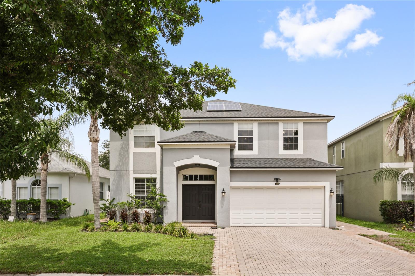 A home that's finally been paid attention to. Four bedrooms, two-and-a-half baths, 2,891 square feet. A full 2022 refresh. New roof, new solar, new water heater, new softener, new stainless appliances, EV charger in the garage. The expensive stuff, already taken care of. Inside, warm engineered hardwood runs uninterrupted through the main floor, from the foyer and dedicated office space into the kitchen and living area that anchors the back of the home. Fresh white cabinets, durable granite counters, stainless appliances, custom tile backsplash. A kitchen you'll love to use and to look at. The bay window pulls in the morning light over the breakfast nook, and the living space is big enough for the family gatherings you'll actually host. Then the rarity, a massive fully screened lanai on brick pavers that stretches the width of the home with ample space to entertain a party of two or twenty, along with a long serving counter ready for a grill setup, drinks station, or whatever the party calls for. Past the screen, the yard is vinyl and stone fenced, artificial turf underfoot so you're not wasting Saturdays mowing. Upstairs, the primary suite carries real volume with a tray ceiling, plus a separate flex space that reads as a sitting area, office, or nursery, really whatever you need it to be. Two walk-in closets built out with custom shelving, and a bath with dual vanities, garden tub, and separate shower. The other three bedrooms are generously sized, all fitted with custom built-ins in the closets. You'd be pleased to know the beauty extends beyond the home itself and into where it sits. You're two minutes from Winter Garden Village. Target runs, AdventHealth, restaurants, shopping for the retail-therapy days, all of it. Ten minutes north drops you onto Plant Street: Crooked Can, the Saturday farmers market, the West Orange Trail running twenty-two miles through the middle of it. Disney sits twenty minutes away so close enough for a Tuesday afternoon, far enough that the tourism doesn't reach here. Not to mention the pool, tennis courts, playground, and clubhouse are all a short walk from the front door, so you don't have to leave the neighborhood to have a good time. If a picture is worth a thousand words, walking through is worth a lifetime. Come see it in person!