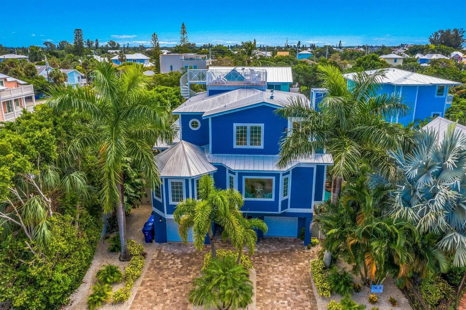 ABOVE IT ALL!, 111 81ST ST It's the home that will give you ALL that Anna Maria Life offers!!! ***** BE SURE TO WATCH OUR FLY THROUGH VIDEO LINK TO CATPURE THE MAGNITUDE OF THIS AMAZING HOME! ***** Welcome to Above it All! And when you are on the 360 degree roof top deck with your favorite beverage, you will truly feel you are ABOVE IT ALL! When you come to Anna Maria Island, you want to live the island lifestyle and this is where you will be able to own your own piece of paradise and live the coveted Anna Maria Life. Above it all has a private heated pool, SPA, poolside entertainment area for everyone to hang out and never miss a game with a new 75" screen outdoor TV! Lounge in the pool side loungers and feel free to dine pool side every meal. It's truly amazing outdoor living and only steps to some the best voted beaches in the world. When you are done with the sun and the sand, come on in to luxury on every floor. You will walk in to the open living space with a newly remodeled Gormet kitchen with design and color you will melt into. This open concept gives you the ability to be with everyone while you dine, play and eat all the local favs. Above it All is a 5 Bedroom and 4 bathrooms with room for 10. Three bedrooms and 2 full baths on the main living floor. Head upstairs to the 2 primaries with ensuites and be able to escape to a bit more privacy. You will see nothing less than its continued beautiful design carried throughout. The professional decore, and all the upgrades will make you feel like you are living in luxury as you live in beach attire! Freshly painted inside and out along with new landscaping for an amazing tropical feel full equipped with new landscape lighting for the full effect. There is so much to take in and enjoy in this home. Above it all is a VERY successful vacation rental. One of the very best rentals on the market on the island. Come see your new home what all the talk is about.