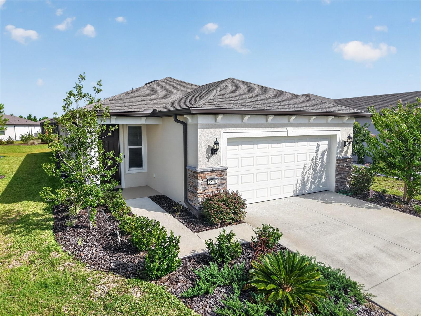 Better than new and ready for you. Built in 2024, this beautifully upgraded 1,656-square-foot home in the 55+ community of Stone Creek, lets you skip the wait and start enjoying the Florida lifestyle from day one. Offering 2 bedrooms, 2 bathrooms, and a versatile flex room, this home features 18-inch tile flooring throughout and an open-concept layout. At the heart of the home, the kitchen is designed for everyday living, featuring a large island, designer backsplash, 44-inch soft-close cabinetry with pull-out shelves, and stainless steel appliances. Pocket sliding glass doors fill the living area with natural light and open to a covered lanai overlooking peaceful green space, creating the perfect spot for morning coffee or evening relaxation. The flex room easily adapts to your lifestyle as a home office, hobby room, media room or guest space. The spacious owner’s suite offers a walk-in closet and an en-suite bath with a walk-in shower and built-in bench, while the guest bedroom and full bath provide a comfortable retreat for visitors. Additional features include a separate laundry room with built-in cabinetry and utility sink, ceiling fans, window blinds, and an extended garage with overhead storage. Enjoy maintenance-free living with an HOA that includes lawn care, irrigation, cable, and high-speed internet. For added peace of mind, the sellers completed a professional inspection before the builder’s one-year warranty expired, and Pulte completed all warranty repairs identified. Located just over a mile from the Reunion Center, this home puts you close to Stone Creek's resort-style pool, fitness center, and full calendar of clubs and activities. Every detail has already been taken care of, so all that is left to do is move in and enjoy everything that makes Stone Creek such a special place to call home.