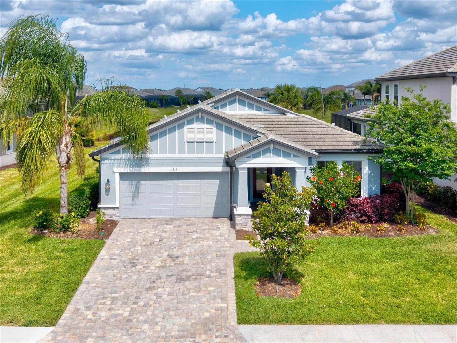 Introducing this gorgeously staged grand residence in the elegant Sweetwater at Lakewood Ranch—where refined design meets effortless luxury. This exceptional, model-quality home is a true showcase of sophistication, with every detail thoughtfully curated to deliver a high-end, turnkey living experience.
From the moment you enter, you’re welcomed by a striking foyer adorned with designer wall coverings, setting the tone for the elevated finishes throughout. The home features upgraded interior doors, custom wood trim and molding, and elegant tray ceilings that add architectural depth and timeless elegance.
At the heart of the home, the gourmet kitchen is a true showpiece—appointed with a premium upgraded kitchen package including waterfall-edge countertops, enhanced cabinetry, designer hardware, and modern lighting that creates both warmth and visual impact.
The primary suite and additional living spaces feature both beauty and functionality. Designed for both luxury and resilience, the home is equipped with hurricane-impact windows and doors, and built-in security system for added peace of mind.
Step outside to your private resort-style retreat featuring a covered pool lanai with tranquil water views, creating the perfect backdrop for relaxation or entertaining. The outdoor living space is further elevated by delivering a seamless indoor-outdoor lifestyle with a true sense of ambiance and privacy. Mature, lush landscaping enhances the overall setting, completing the home’s impressive curb appeal.
Beyond the home, Sweetwater offers an elevated lifestyle with resort-inspired amenities including a beautifully appointed clubhouse, sparkling resort-style pool, state-of-the-art fitness center, playground, and scenic walking trails.
Perfectly positioned in the heart of Lakewood Ranch, you are just moments from Waterside Place, Lakewood Ranch Main Street, and University Town Center—home to upscale shopping, dining, and entertainment. Top-rated schools and the world-renowned Gulf Coast beaches are all within easy reach.
This is more than a home—it is a statement of luxury, lifestyle, and distinction!