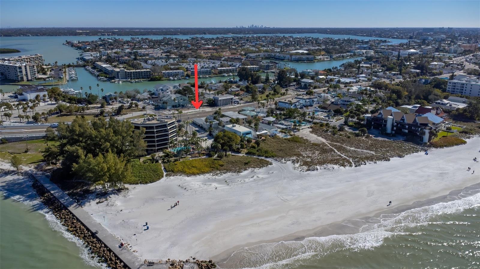 One or more photo(s) has been virtually staged. 
Prime Hospitality Investment Opportunity Steps from Sunshine Beach!  Currently on the land is The Sand Dune Suites, operating with hotel/motel zoning, this property allows for highly lucrative nightly rentals. Currently a quadraplex/motel and each of the four distinct units offers its own unique charm and structural blueprint, promising exceptional turnkey returns once fully restored. 
Literally steps from the pristine shores of Sunshine Beach and a short, scenic stroll away from historic John’s Pass Village. Property highlights include a serene common courtyard for outdoor relaxation, and dedicated on-site parking for each unit Please note: Interior photos reflect the property prior to recent storm damage. Three of the four units are ready for interior remodeling. The second-floor unit is accessible for immediate owner or manager use during renovation. Unlock massive ROI as this 4-unit property is zoned for profitable nightly hotel/motel rentals. Exceptionally well priced and a wonderful property as well as investment