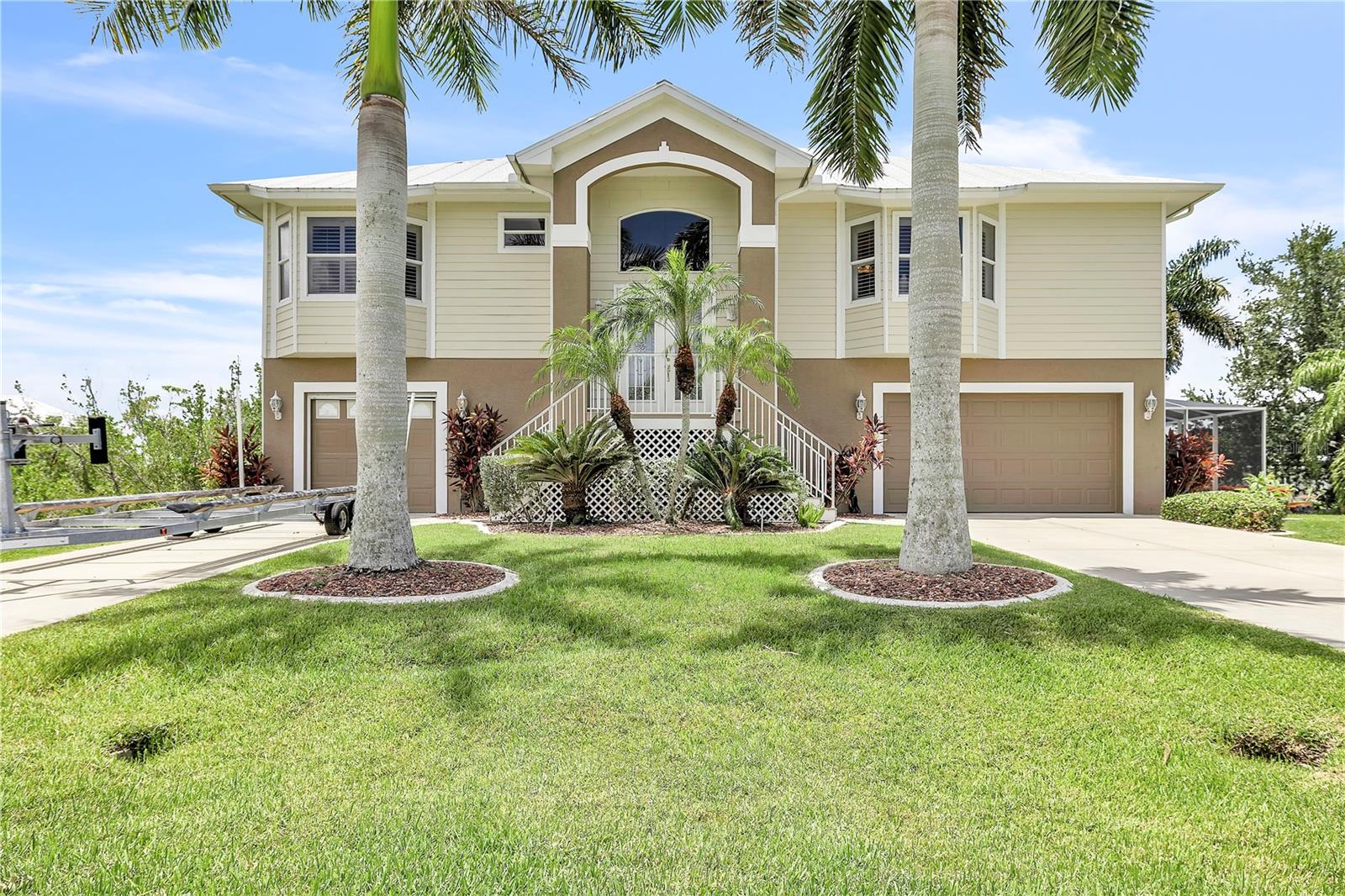 Welcome to your dream waterfront retreat in the highly sought-after community of Pirate Harbor! Custom-built and lovingly maintained by its original owner, this exceptional residence offers the perfect blend of luxury, comfort, and Florida waterfront living. Designed to maximize breathtaking southern exposure and spectacular sunset views, the main living level features 3 bedrooms, 2 bathrooms, and an open-concept floor plan with pocketing sliding glass doors that seamlessly connect the indoor and outdoor living spaces. The spacious kitchen is equipped with solid wood cabinetry, double wall ovens, gas cooktop, and abundant workspace, making it ideal for entertaining. Step outside to your expansive screened lanai overlooking the canal, where you'll enjoy a heated chlorine pool and easy access to the water. Boaters will appreciate the 10,000-pound boat lift and the quick 5 minutes to the Harbor & 20-minute ride to the Gulf, offering endless opportunities for fishing and sunset cruises. The versatile lower level is an entertainer's dream, featuring an oversized game room complete with a large wet bar and full bathroom. Whether you envision a media room, guest retreat, private studio apartment, or mother-in-law suite, this flexible space offers endless possibilities. Additional premium features include an elevator, durable metal roof, Hardie Board siding, plantation shutters throughout, whole-house reverse osmosis system, sprinkler system, and an oversized three-car garage. The home has a propane service to provide gas for the gas cooktop, outdoor grill, and fireplace. Recent updates include a new HVAC system (2024), pool cage replacement (2017), and water heater (2021). This is more than just a home, it's a rare opportunity to own a meticulously cared-for, custom waterfront property where every detail has been thoughtfully designed for enjoying the Southwest Florida lifestyle.