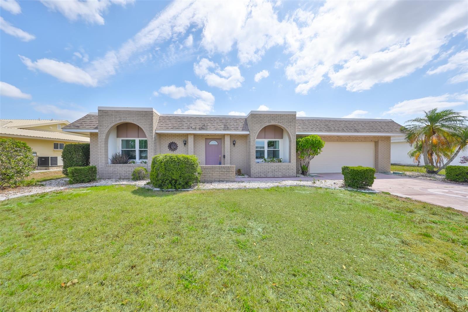 Discover your next home in the heart of Sun City Center, where the perfect blend of tranquility and convenience awaits.  One of the most affordable single family homes available in Sun City Center with A GARAGE, FENCING ALLOWED, AND NO HOA!  Welcome to this charming 2 Bed/2 Bath, 1226 Sq Ft Adventurer model residence, cared for by owners who have cherished this property. Notable Features: Additional insulation added for energy efficiency; Upgraded windows for improved aesthetics and energy efficiency; HVAC and roof recently improved and serviced, ensuring peace of mind.  Compliant plumbing and electrical systems; A picturesque backyard with a birdbath that attracts local wildlife. This home is not just well-maintained; it's a superb value for those seeking a residence ready for immediate occupancy or as a winter haven. Sun City Center is a premier 55+ community, offering a vibrant senior lifestyle with numerous amenities. A short golf cart ride connects you to the Community Association Campus, where you'll find pools, hundreds of clubs, and entertainment options. Beyond the community's offerings, you'll appreciate the convenience of being close to world-class beaches, a wide array of cultural and sports venues, and Tampa International airport. Full of Volunteer Opportunities such as the Sun City Center Emergency Squad, Samaritan Services, and Security Patrol, you could find yourself in the second career of your life! Convenience is at your doorstep, with shopping and services easily accessible by golf cart. Your new home opens the door to endless recreational and exploratory opportunities. This is why Realtor and Travel & Leisure Magazine named Sun City Center as the TOP RETIREMENT COMMUNITY in the UNITED STATES?! Come to this this welcoming community and live life you've always dreamed of in a 55 and better paradise!
