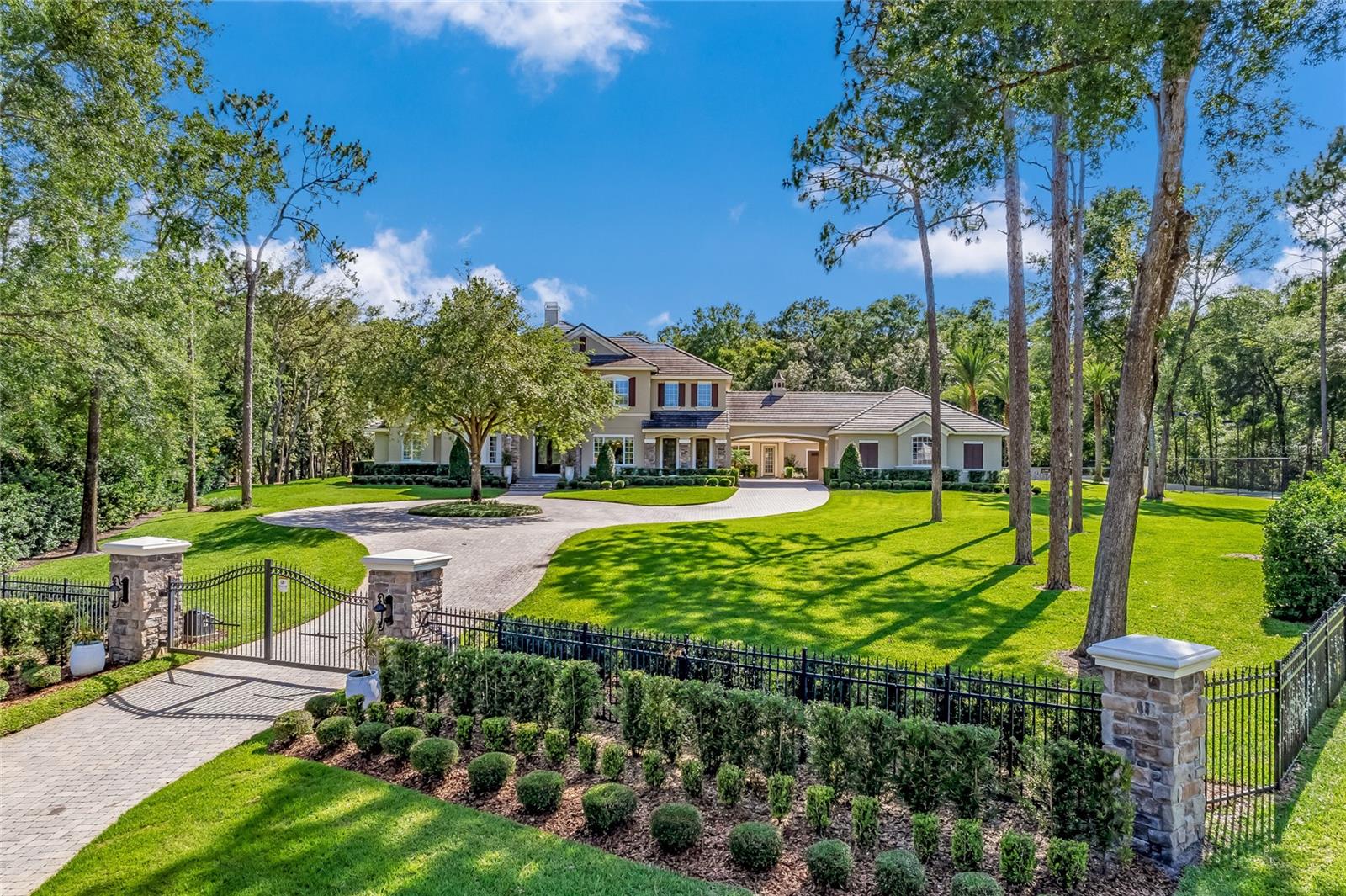 ** Step inside and tour this home via the video tour link. This link is also available on Zillow under facts and features, “other features” of this property.** Welcome to this luxurious estate home, nestled in the prestigious guard gated
Sweetwater Club in Longwood, Florida. Spacious lots and winding streets lined
with majestic oak trees offer beauty and privacy to the residents.
Nestled on a cul-de-sac,  the home’s private entry gate opens to a circular
driveway, porte-cochere connecting to the paver motor court with the 6-car split
garage.
6 bedrooms, 6 bathrooms, and 2 half baths span over 7,405 square feet
gracefully set on the fully fenced 2.76-acre lot.
The grand foyer entry opens to soaring ceilings, gleaming marble floors, and
grand staircase.
An elegant formal living room just off the entryway provides a tranquil seating
area. The formal dining room is perfect for hosting lavish dinner parties.
The spacious gourmet chef’s kitchen and adjacent casual dining area feature top
of the line stainless steel Thermador appliances with a heat shift induction
cooktop, custom cabinetry, and large center island.
A true sanctuary, the first-floor primary suite includes a sitting area, walk-in
closets, and spa-like bathroom complete with a soaking tub and walk-in shower.
Additionally located on the first floor is a bedroom suite opening out to the pool
area. The remaining 4 full-bedroom suites are located on the second floor along
with a bonus room, and 2 flex space utility/storage rooms.
Just a few of the standout features in the home are custom crown moldings,
coffered ceilings, and built-ins that will impress the most discerning buyers.
But the luxury doesn’t stop inside the home. Step outside from multiple rooms
into your private oasis complete with a resort-style heated pool and spa with
Tennessee rock waterfalls, your own stadium-lighted tennis court, basketball
court, putting green and butterfly garden.
With plenty of space for seating and lounging, the expansive patio offers the
perfect setting for al fresco dining and entertaining. The grounds are thoughtfully

designed with lighting and surround sound, providing the perfect atmosphere for
any occasion.

Every detail about this home has been carefully thought out down to the two 3
car garages. To care for luxury cars one garage is climate controlled while both are
finished with epoxy granite chip floors and insulated carriage doors.
Sweetwater Club has access to Lake Brantley for boating, fishing, and skiing.
Nearby Wekiva State Park, is popular for canoeing in the Springs.
This is truly an exceptional opportunity to own a one-of-a-kind estate in one of Longwood's most sought after neighborhoods.