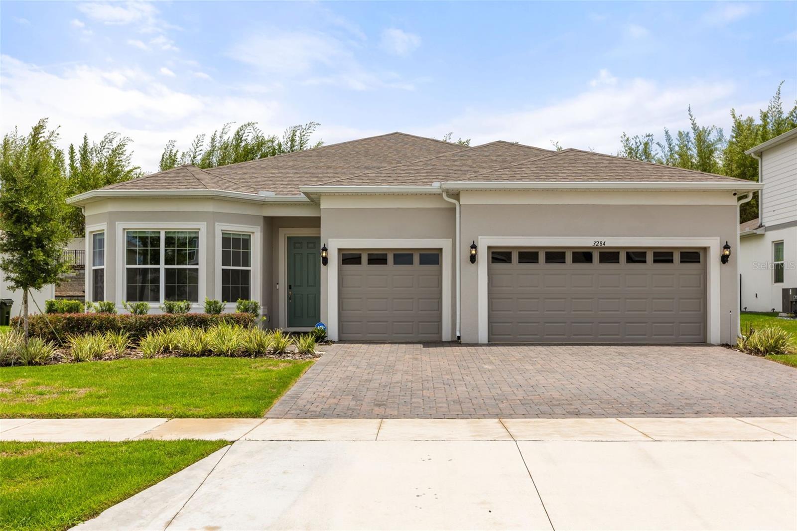 Step into this bright and inviting single-story home in the gated Lakeview Preserve on Johns Lake. Featuring a 3-car garage, tray ceilings, recessed lighting, and large-format tile, the open-concept living spaces are perfect for entertaining and everyday living. The white shaker kitchen stands out with an oversized quartz island with seating, built-in wall oven and microwave, cooktop with stainless hood, walk-in pantry, and abundant prep space.

The luxurious primary suite boasts dual sinks, an oversized walk-in shower with upscale tile, and a custom walk-in closet. Secondary bedrooms are generously sized, and the laundry room includes upper cabinetry and a utility sink. Outdoor living is highlighted by a covered paver lanai and privacy-buffered backyard with no rear home in view, creating a serene retreat.

Lakeview Preserve offers resort-style living with a pool, splash pad, playground, fitness center, cabana/clubhouse, plus direct Johns Lake access with a dock and kayak launch. Enjoy nearby Winter Garden Village, Downtown Winter Garden with dining, arts, farmers market, and West Orange Trail access, plus convenient access to parks, shopping, and Lake County schools. This move-in-ready home blends style, comfort, and an unbeatable location for lifestyle and convenience.
