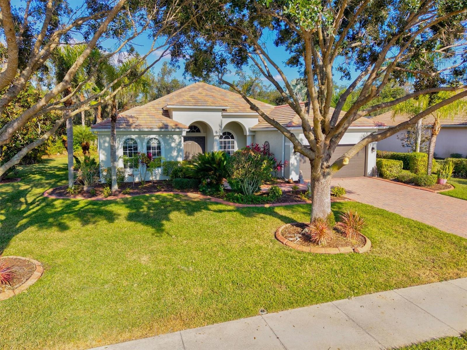 Looking for peace and serenity? Enjoy the quiet surroundings and beautiful natural views in this well maintained 4 bedroom, 2.5 bath home on nearly a 1/2 acre with no rear neighbors and a lovely pond view in front. Located in the highly sought after community of Country Meadows, this home offers an ideal blend of privacy and convenience featuring an open floor plan, high ceilings, updated kitchen with abundant counter seating, and large screened in lanai with pool.  The kitchen flows seamlessly into the great room, perfect for gatherings and entertaining family and friends. A cafe area and separate dining area provide additional hosting spaces. The primary suite is privately positioned, offering a peaceful retreat with an en-suite bath and walk in closet. The split bedroom layout for guests ensures privacy for all. A spacious 21x15 bonus/flex room with half bath offers endless possibilities for a game room, media room, entertainment space, and so much more. Step outside to your stunning pool area, ideal for enjoying Florida days and evenings swimming, cooking (plumbed for outdoor kitchen) or simply relaxing. Recent upgrades include high-efficiency HVAC, new water heater. and fresh interior and exterior paint (all in 2024). Additional highlights of the home include a 3 car tandem garage perfect for car enthusiasts, hurricane shutters for peace of mind, NO flood insurance needed. 
. Country Meadows is a deed-restricted, gated Community with low HOA fees, NO CDD fees, and served by A-rated schools. The home is conveniently located near 1-75, shopping (Costco, Target, Home Goods), multiple restaurants, medical facilities, and minutes to sun filled Gulf beaches and parks. Experience an amazing community and an unbeatable lifestyle; your Florida dream home awaits!