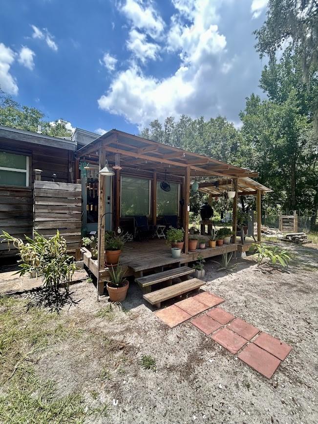 Where the City Meets the Country — 6.5 Acres of Total Privacy in Fish Hawk Schools

Tucked away on 6.5 total acres across two parcels (5.5 + 1), this rural Wimauma retreat offers something increasingly rare: absolute solitude without any neighbors in sight, all while staying zoned within the highly sought-after Fish Hawk school district. Whether you're craving room to breathe, space for animals, hobbies, or simply a quiet escape from the everyday hustle, this property delivers — without sacrificing easy access to city conveniences.

The 3-bedroom, 2-bath home is wrapped in durable 1" cypress siding, giving it timeless, natural character that's as practical as it is beautiful. A brand-new roof (2022) and new drain field (2023) mean major systems are already taken care of, so you can focus on making this land your own.  Take advantage of the 2nd bathroom mid-renovation to add your own style and finishes.

Outbuildings abound: a substantial 20x30 metal building plus two additional storage structures provide ample space for equipment, workshops, vehicles, or whatever your next project calls for. Raise your own chickens in the 10x20 chicken run and 5x5 coop, all secured with 1" welded wire buried 8" deep.  With agricultural zoning allowing one house each acre, there's flexibility for future plans, whether that's expanding, subdividing, or simply enjoying the wide-open space as-is.

This is country living with room to roam — peaceful, private but close to the city life.
Owner is licensed real estate agent.