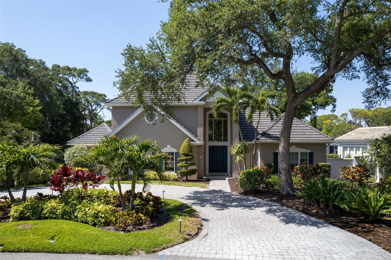 Welcome to an exceptional estate in The Oaks Bayside, where timeless elegance meets modern luxury in one of Sarasota County’s most prestigious gated communities. Perfectly positioned on a private, lush homesite beneath a canopy of majestic oaks, this stunning 5-bedroom, 6-bath residence offers the ideal blend of space, sophistication, and serenity.  Step inside to discover a thoughtfully designed floor plan with expansive living areas, soaring ceilings, and an abundance of natural light. At the heart of the home is a completely renovated chef’s kitchen, featuring high-end finishes, premium appliances, custom cabinetry, and a seamless flow into the main living and entertaining spaces, perfect for both everyday living and hosting guests in style. Each of the five spacious bedrooms offers comfort and privacy, while the six bathrooms provide ample convenience for family and guests. Recent updates include a brand-new roof, and renovated kitchen, offering peace of mind and long-term value for the next owner.  Outdoor living is equally impressive, with tranquil surroundings that capture the essence of Florida living, ideal for relaxing, entertaining, or simply enjoying the natural beauty that defines The Oaks Bayside.
Residents enjoy access to The Oaks Club, a private, member-owned country club offering championship golf, tennis, fitness, dining, and a vibrant social lifestyle. Conveniently located near top-rated schools, beaches, dining, and shopping, this home delivers the perfect balance of privacy and accessibility.
Experience refined living in one of the area’s most sought after communities, this is more than a home, it’s a lifestyle.