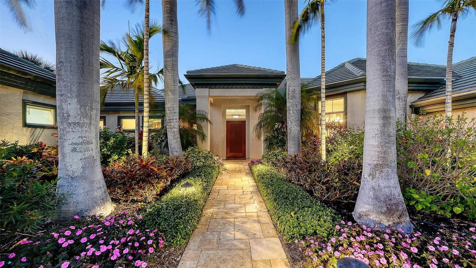 Experience serene waterfront living in this custom residence on Bird Key, one of Sarasota’s most prestigious island communities. This exceptional property presents a rare opportunity to own a private slice of paradise, offering sweeping bay views, refined coastal design, and an extraordinary lifestyle at an outstanding value. Designed for both comfort and entertaining, the home features three spacious en-suite bedrooms, including a luxurious primary suite that serves as a tranquil retreat. Wake each morning to panoramic water views, unwind in a spa-inspired hydra-jet soaking tub framed by bay windows, and enjoy dual walk-in closets, dual vanities, and a separate glass-enclosed shower.
Rich oak floors, a welcoming fireplace, and custom cherry-wood cabinetry add warmth and sophistication throughout the open-concept living spaces. Double glass doors lead to an expansive lanai, perfect for sunrise coffee or sunset cocktails beside the free-form pool. The generous patio offers multiple seating areas, while a private dock with a 16,000-lb. lift invites effortless boating, kayaking, and fishing adventures. From your backyard, watch dolphins and manatees glide by, with the Gulf of Mexico just a short ride away. The chef’s kitchen is equally impressive, appointed with premium appliances, a six-burner Dacor gas range with dual ovens, rich cherry cabinetry, a central island, and a Sub-Zero wine refrigerator—ideal for hosting unforgettable gatherings. Outside, a circular paver driveway, mature tropical landscaping, and stately Royal Palms create a grand first impression. Positioned on a spacious, protected boat basin with coveted western exposure, the home captures Sarasota’s legendary sunsets in spectacular fashion. Located just two miles from downtown Sarasota’s vibrant arts scene, fine dining, and boutique shopping, the property also offers close proximity to St. Armands Circle and the pristine shores of Lido Beach—placing world-class shopping, dining, and white-sand beaches within easy reach. This is waterfront living at its finest—where elegance, comfort, and coastal beauty meet.