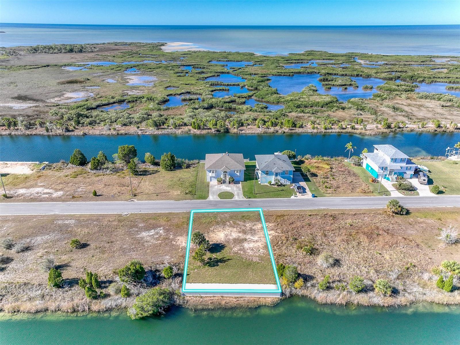OWNER FINANCING AVAILABLE! Build your dream coastal retreat on this OVERSIZED WATERFRONT LOT with STUNNING OPEN WATER GULF VIEWS and INDIRECT GULF ACCESS in the heart of Hernando Beach! This 7,100 SF (71x100) homesite features a BRAND-NEW SEAWALL AND CONCRETE 8’ WIDE CONCRETE CAP and offers the perfect opportunity to create your ideal waterfront getaway with no timeline to build. Conveniently located just minutes from the Hernando Beach Boat Lift, you’ll enjoy easy access to the Gulf for boating, fishing, and sunset cruises.
Zoned R1B for SINGLE-FAMILY HOMES only (no mobile homes permitted). Property is located in Flood Zone AE, so any future home will need to be elevated. Water, sewer, and electric are available at the street and can be connected during construction. Docks are permitted even without a home currently built on the property.
NO HOA, NO DEED RESTRICTIONS, and NO SHORT-TERM RENTAL RESTRICTIONS make this an excellent opportunity for a primary residence, vacation home, or investment property. Please note this is NOT an RV lot and RV living is not permitted.
Enjoy the laid-back coastal lifestyle Hernando Beach is known for, with nearby waterfront restaurants, live entertainment, local marinas, and endless outdoor recreation. Just a short drive away, Weeki Wachee Springs offers kayaking, paddleboarding, boating, and crystal-clear natural springs. Rare opportunity to own a waterfront lot with Gulf views, flexible ownership options, and incredible potential!
Lot lines shown in aerial photos are approximate. Property is located on the left side of the road across from 3267 Lugustrum Drive. Land financing options available.