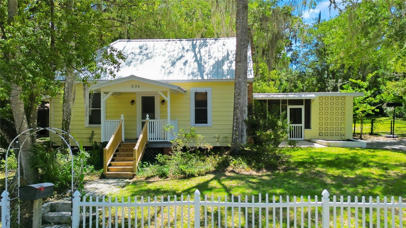 Welcome to this charming 3-bedroom, 2-bathroom cottage-style home nestled in the heart of Brooksville. Located along a picturesque brick-lined street and within walking distance of the historic downtown district, this property beautifully combines timeless character with modern updates.

Situated on just over half an acre, this bright and inviting home has plenty to offer both inside and out. The cozy living room features a working brick fireplace, creating the perfect setting for relaxing evenings at home. Rich original 1930s pine flooring adds warmth and character throughout the living room and all three bedrooms.

The updated kitchen is filled with natural light thanks to numerous windows and two skylights positioned above the spacious center island, which comfortably seats four and serves as a wonderful gathering place for family and friends.

The home's thoughtful layout includes two guest bedrooms connected by a Jack-and-Jill bathroom with a shower, while the primary suite enjoys the privacy of its own en-suite bathroom featuring a tub/shower combination.

Recent improvements provide added peace of mind, including a new roof (April 2026), new water heater (June 2026), new front porch steps (May 2026), and kitchen updates that blend functionality with charm.

Step outside and discover the rare opportunity to enjoy more than half an acre within city limits. Whether you envision lush gardens, outdoor entertaining spaces, or your own private retreat, the expansive yard offers endless possibilities. A screened porch located between the home and the exterior laundry room provides a comfortable, sheltered space to enjoy the outdoors year-round.

This delightful Brooksville home is full of character, charm, and opportunity. Schedule your private showing today and experience all that this special property has to offer.