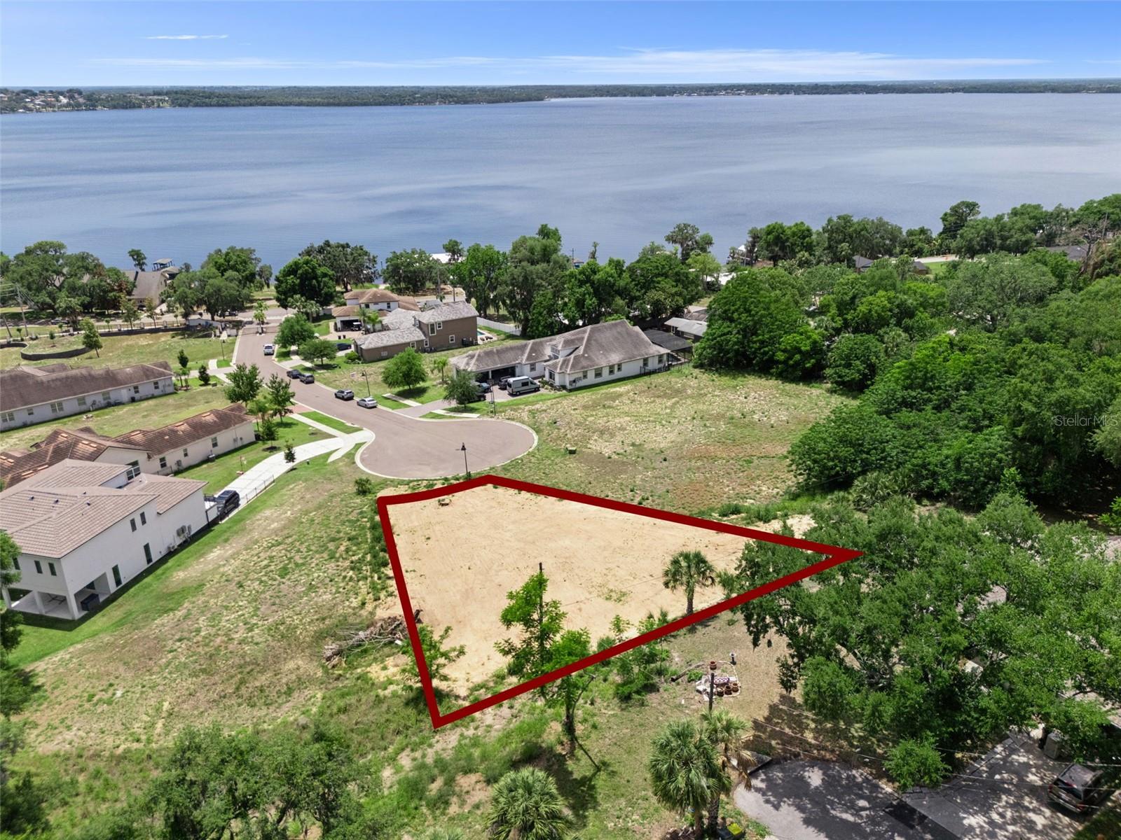 ***King of the Hill*** 1849 Moorings Court presents a rare opportunity to build your custom masterpiece within the exclusive gated community of The Moorings in Clermont. Perched atop one of the highest vantage points in the entire neighborhood, this premium 0.32-acre cul-de-sac homesite offers what are arguably the most commanding, panoramic views of Lake Minnehaha and the renowned Clermont Chain of Lakes in the community. This exceptional elevation creates a truly unique canvas to design a luxury residence that maximizes breathtaking sunset vistas and the serene atmosphere of highly sought-after lake-view living. The Moorings is an intimate, boutique enclave featuring only a limited number of upscale homesites, providing a peaceful and private setting surrounded by natural beauty. Residents enjoy exclusive access to the community boathouse, making it effortless to embrace an active outdoor lifestyle filled with boating, jet skiing, paddleboarding, and fishing. This lot is completely cleared and build-ready, with essential utilities including water, sewer, and electricity easily accessible and nearby, significantly streamlining the process to bring your own builder and construct your custom luxury estate. Perfectly blending tranquility with convenience, this property is located just minutes from Historic Downtown Clermont, offering easy access to local dining, boutique shopping, waterfront parks, and scenic walking trails. Widely recognized as the "Choice of Champions," Clermont is famous for its rolling hills, pristine lakes, and world-class outdoor recreation. Commuting throughout Central Florida is simple and efficient with quick access to major highways, placing Orlando's world-famous theme parks, the international airport, and premier medical facilities all within easy reach. Opportunities to secure a premium lake-view homesite with this level of elevation in a boutique gated community are vanishingly rare. Whether you envision a modern estate or a timeless transitional retreat, 1849 Moorings Court offers the chance to build something truly spectacular.