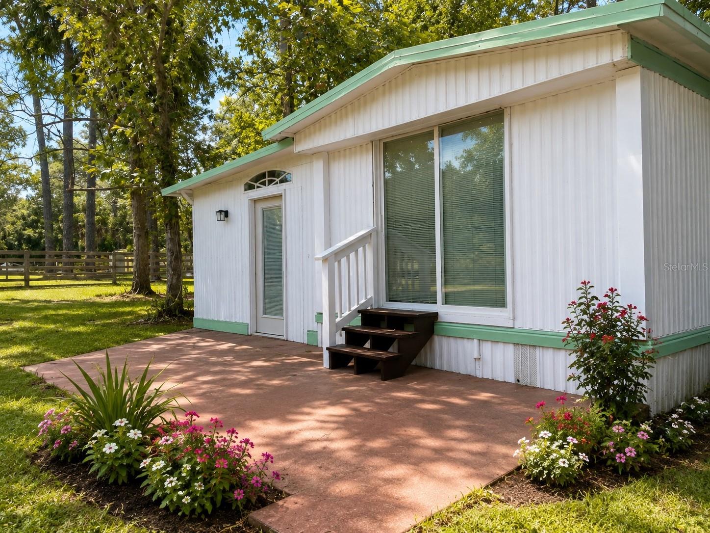 Discover the perfect blend of privacy and convenience in Crystal River. Tucked away on a private access road and surrounded by mature trees and lush landscaping, this beautifully updated  home offers a peaceful retreat just minutes from downtown Crystal River, shopping, restaurants, marinas, and the area's world-famous springs and waterways. Extensively renovated and move-in ready, the home features a brand-new well and septic system, a new mini-split HVAC system, updated electrical panel and service pole, updated water heater, fresh interior paint, luxury vinyl plank flooring, and new sliding glass doors. The fully renovated bathroom showcases modern fixtures and finishes, while the bright and inviting interior is filled with natural light from oversized windows overlooking the wooded surroundings. The updated kitchen is designed to impress with butcher block countertops, stylish tile backsplash, stainless vent hood, and newer appliances. The open layout creates a spacious feel throughout the home and provides comfortable living spaces for everyday living or weekend getaways. Outside, enjoy the tranquility of your private wooded setting complete with mature landscaping, a covered patio, storage shed, and fenced yard. Whether you're looking for a full-time residence, seasonal retreat, or investment opportunity, this property offers the rare combination of modern updates, privacy, and proximity to everything Crystal River has to bring to the table. Schedule your private showing today and experience this hidden gem