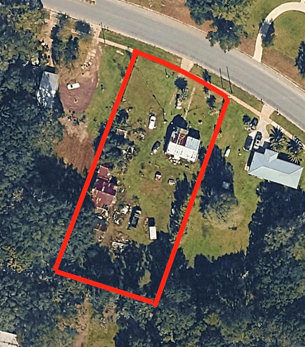 Investment opportunity in the City of Lawtey! This 2.4-acre property offers excellent potential for investors, builders, and developers. Located on Lake Street, the property features road frontage and a variety of possibilities for future use. The existing home is in poor condition and conveys at no value. Also included are three metal barns that provide additional storage or utility. The value is in the land. Property is being sold AS-IS. Buyers are responsible for verifying zoning, land use, dimensions, and any future development or permitted uses with the appropriate governmental authorities. Schedule your showing today and explore the potential this property has to offer.