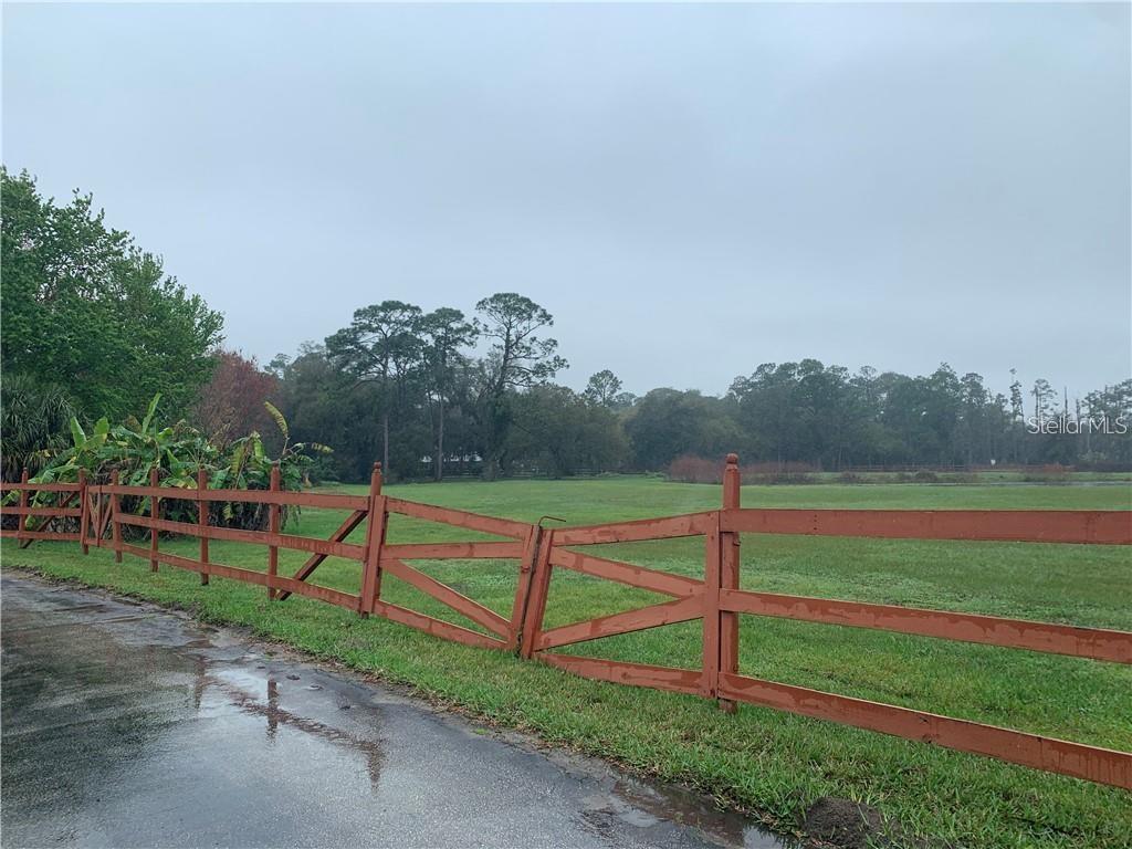 Opportunity Knocks!  Don't miss this chance to own over 6 acres of land in Saint Cloud. There are two commercial shops, one is 60x40 and the second one is 100x50; an additional 160x60 open shop with concrete floors, and 14 bays with 14 roll up doors. There is a pond on the property. Enjoy the view of Alligator Lake.
