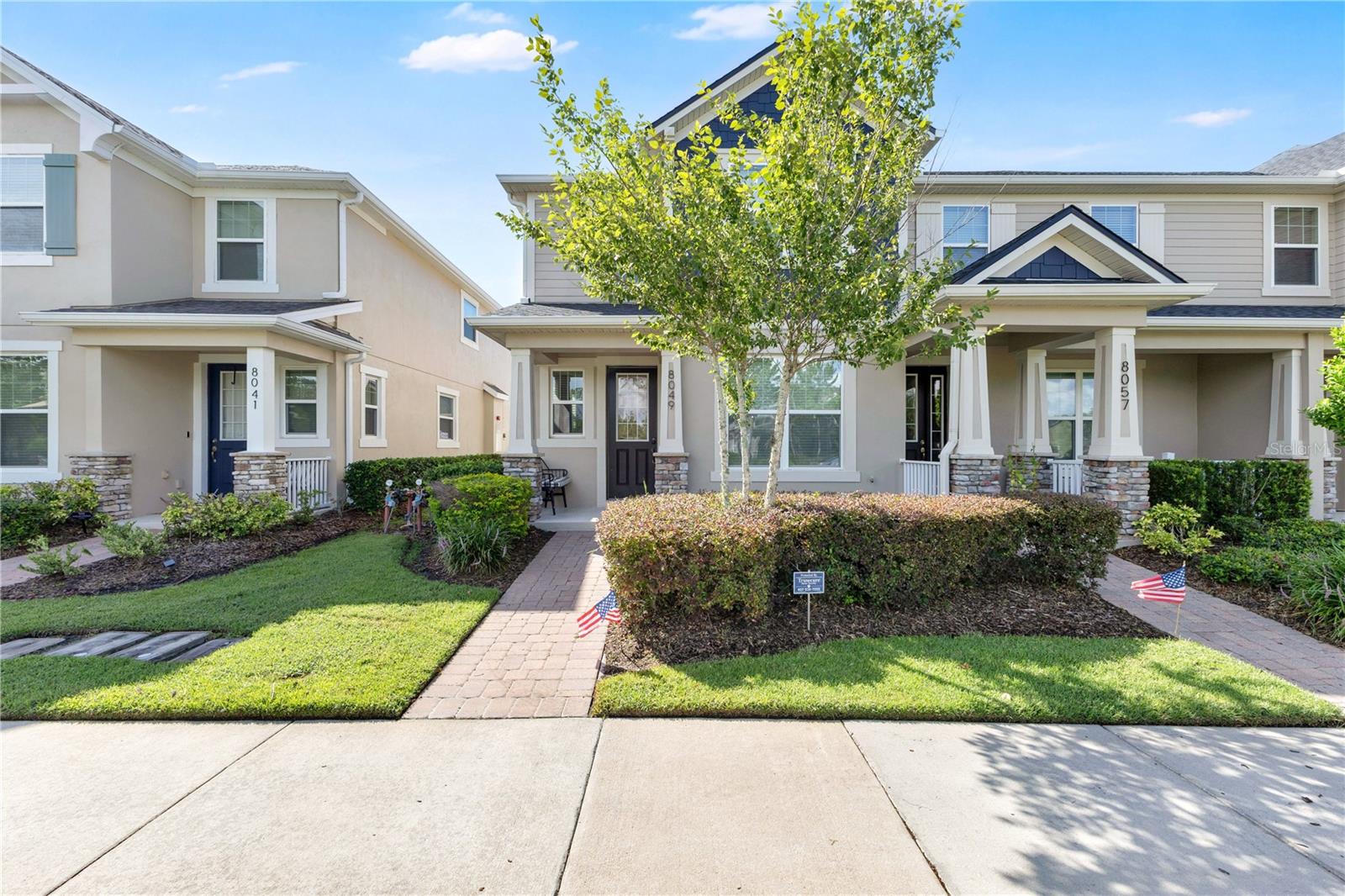 Situated in the highly desirable Randal Park community of Lake Nona, this beautifully maintained 3-bedroom, 2.5-bathroom townhome offers the perfect blend of modern style, comfort, and convenience. A charming covered front porch and professionally landscaped walkway create an inviting first impression, while the rear-entry detached two-car garage and private brick-paver courtyard provide both functionality and privacy.

Step inside to discover a bright, open-concept layout filled with natural light and enhanced by crown molding, recessed lighting, and beautiful wood flooring throughout the main living areas. The spacious living room flows seamlessly into the kitchen, creating an ideal space for everyday living and entertaining. The chef-inspired kitchen features rich espresso cabinetry with crown molding, granite countertops, stainless steel appliances, a custom tile backsplash, abundant cabinet storage, and a large center island with bar seating overlooking the living area. Just off the kitchen, a flexible bonus room with glass French doors provides the perfect space for a home office, playroom, media room, or guest bedroom, offering versatility to fit your changing needs.

Upstairs, the spacious primary suite serves as a relaxing retreat, highlighted by an elegant tray ceiling and generous walk-in closet. The luxurious en-suite bathroom features dual granite vanities, a soaking tub, and an oversized walk-in glass shower with floor-to-ceiling tile. Two additional bedrooms provide comfortable accommodations for family, guests, or hobbies, while the upstairs laundry room adds everyday convenience.

Step outside to enjoy your private, fully fenced brick-paver courtyard, offering the perfect setting for grilling, outdoor dining, or relaxing with friends and family. Residents of Randal Park enjoy exceptional amenities including a resort-style pool, fitness center, playgrounds, dog parks, scenic walking trails, parks, and green spaces. Ideally located just minutes from Medical City, Orlando International Airport, shopping, dining, top-rated schools, and major highways, this move-in-ready home offers the perfect combination of low-maintenance living and an unbeatable Lake Nona location.