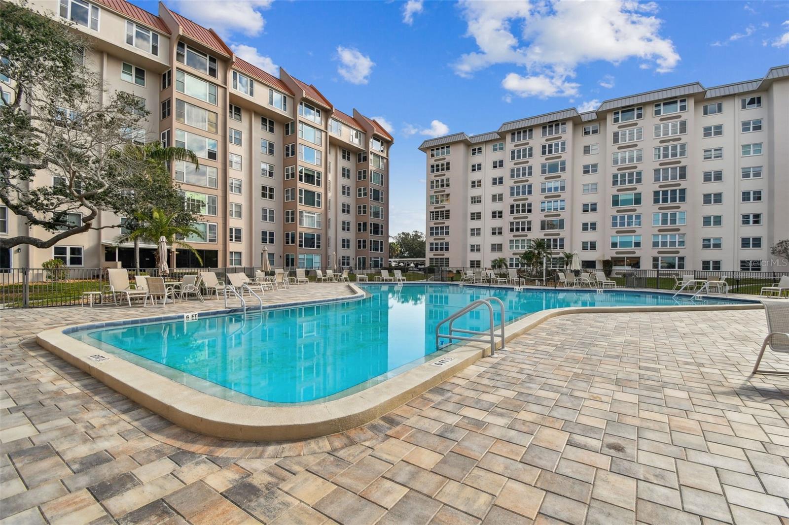 MUST SEE! Shows like a model! Recently renovated condo in Edgewater Arms with pool and water views! Lots of natural light. Luxury vinyl plank flooring throughout. Kitchen features newer cabinets, backsplash, appliances and an island. Beautiful quartz countertops. New electrical panel, water heater, baseboards and fixtures. Open floor plan. Only condo with office space next to foyer. Master suite accommodates a king size bed and has a custom California closet. Florida room has custom shades with custom bar with wine refrigerator and great views of the pool. Conveniently located to all the amenities of downtown Dunedin within walking distance. Biking enthusiasts can enjoy being on the Pinellas Trail or use the trail for recreation. Dunedin is golf cart friendly and home to one of the best beaches in the country at Honeymoon Island Park. Relax on the fishing pier and catch some dinner. There is kayak and bike storage available. Come check out the Dunedin lifestyle!