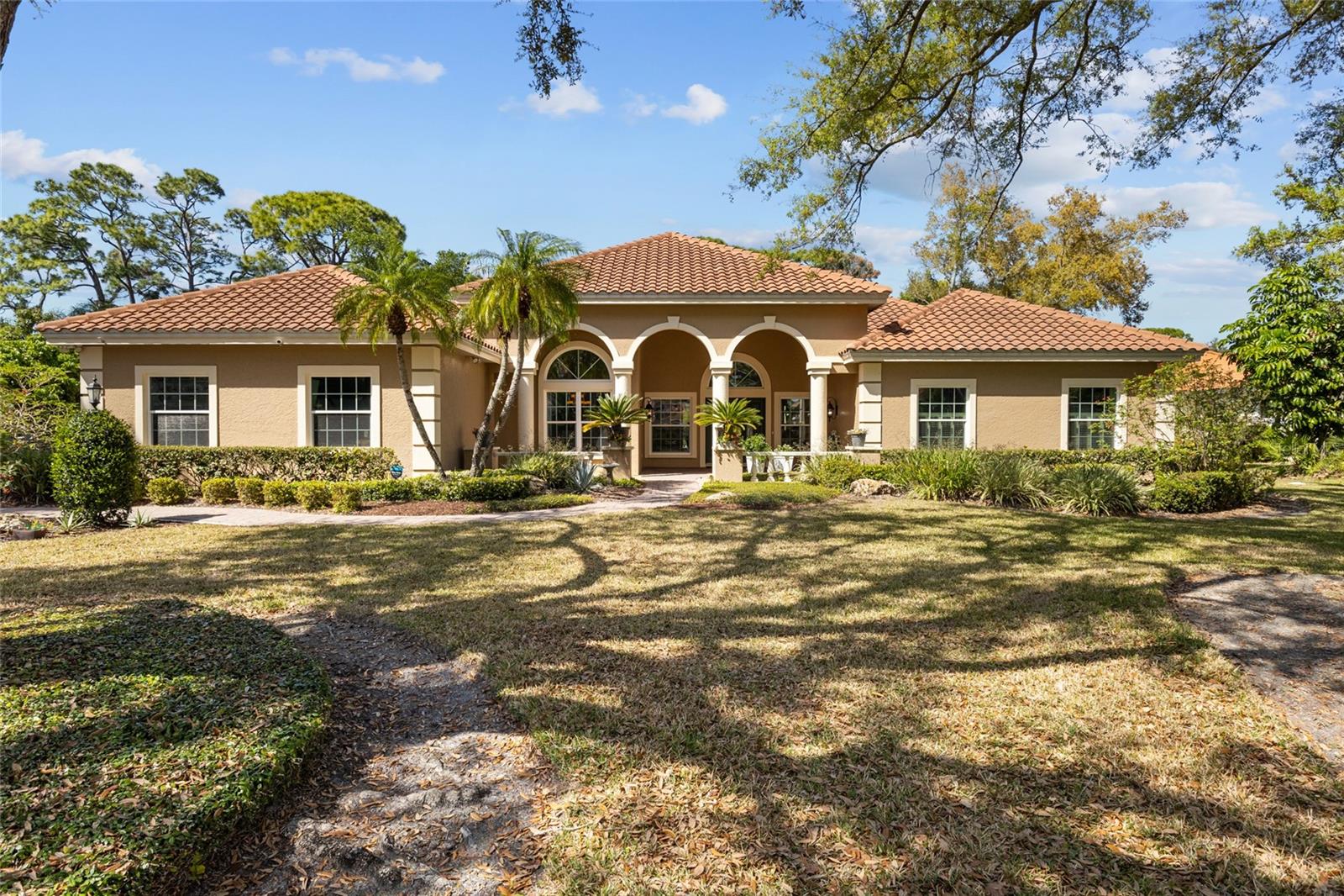 Set on one of the most desirable streets in TPC Prestancia, this residence offers the presence and grace of a classic estate enhanced with a touch of Mediterranean flair. Mature oak trees frame the property, while towering pines along the rear create a beautiful natural backdrop that complements the home’s timeless architecture. The setting is completed by immediate, sweeping views of the golf course, bringing light, openness, and the signature Prestancia landscape right to your lanai.

Inside, the home features 4 bedrooms (one currently used as an office), 3 full bathrooms, all arranged with a sense of scale and refinement. High ceilings, generous room sizes, and large windows create bright, inviting living spaces. The traditional gourmet kitchen, open towards the family room is designed for both everyday comfort and entertaining, offering granite countertops, classic cabinetry, high-end stainless-steel appliances (Miele dishwasher, Wolf cooktop), large pantry and excellent workspace. A formal dining room adds an elegant space for gatherings and special occasions, perfectly positioned within the home’s traditional layout. The living-room with sliding doors blends seamlessly indoor and outdoor living.

The outdoor living area is a highlight: sparkling pool and spa and an expansive screened lanai ideal for relaxing or hosting. The views of the manicured fairways and the surrounding natural landscape make this space feel both elegant and serene. In addition, the side yard offers ample space to gather and play.

Significant updates add peace of mind, including impact windows and sliders, two new AC units, brand-new pool cage, new water heater... These improvements blend seamlessly with the home’s classic character (arches, crown moldings, plantation shutters, hardwood floors) offering modern comfort within a timeless setting. Laundry and two-cars garage complete the property.

TPC Prestancia community provides 24/7 gated security and is recognized as an Audubon Certified Sanctuary, with 565 acres of mature trees, wildlife, and walking paths. Fine dining, shopping is only minutes away! Located only 4 miles from world-renowned SIESTA KEY BEACH, this home blends golf course tranquility with exceptional coastal convenience.

TPC Prestancia social, sports (tennis, brand new pickleball courts, gym in construction) and golf memberships are available and optional.

This is a rare opportunity to own a home, move in condition that combines estate-level presence, thoughtful updates, and one of the most attractive golf-course settings in Sarasota. Schedule your private showing today. Floorplan and 3D tour available