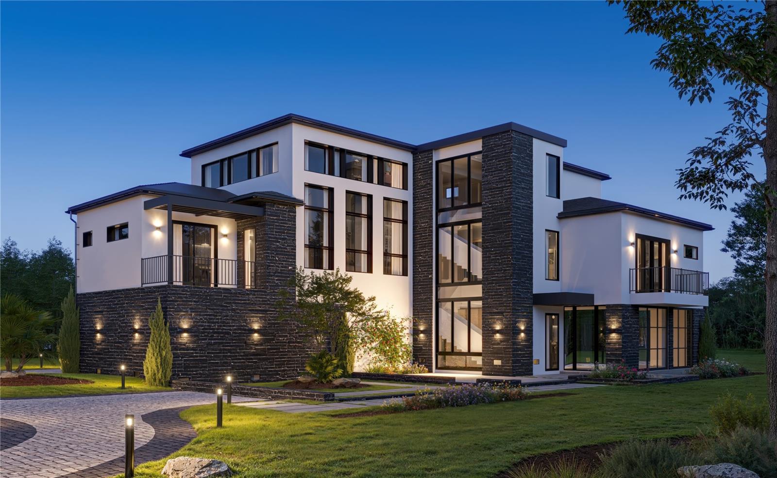 Virtually Staged. Under Construction. Welcome to Marsh Pointe, Tampa’s newest gated enclave of modern luxury living. This brand-new contemporary coastal-modern residence blends architectural sophistication & ICF exterior construction; which is rarely offered in this market, for energy efficiency, moisture resistance & storm resilience. This home offers clean lines, soaring ceilings, and an open-concept design that floods the home with natural light. Upon arrival, you will note a private courtyard garden & reflection pool. Take in the breathtaking large curtain wall window with architectural stair feature upon entry & you’ll further experience the openness of this home. 
The gourmet kitchen serves as the heart of the home, featuring premium cabinetry, quartz surfaces, an oversized island, top-tier appliances & a separate scullery kitchen ideal for both entertaining & daily living. The main living area features 21’ ceiling which transitions seamlessly from kitchen to living room, ideal for entertaining around the fireplace. 
The luxurious primary suite is a serene retreat with a generous walk-in closet & a spa-inspired bath, dual vanities, oversized shower and built-in coffee bar for a true private retreat feel. Additional bedrooms provide flexibility for guests including a private guest suite. Working from home takes on a new meaning in your dedicated home office/flex room.
Ascend to the upper levels of this home via the elevator servicing all floors & take in the expansive 2nd level view of the living room down below where another fireplace awaits. Adjacent to this opening you will find two more generous bedrooms & media room/lounge.
The main level of the home opens to the enclosed & dedicated high performance wellness level including a performance studio gym, recovery/spa pavilion & an enclosed pool with full pool bath & spa-style rinse shower. Easily transition to your outdoor space, where a covered lanai overlooks a private backyard with enclosed pool. Steps away is your covered, outdoor kitchen & entertaining area. Tranquility also awaits outside your door with a reflection pond & courtyard garden. All the elements come together to create a home that is a masterpiece of art; thoughtfully designed luxury lifestyle residence focused on privacy, wellness and long-term quality.
Additional features of this home are the impact-rated windows & doors, tankless water heaters, water softener system, plus smart home integration throughout. Located in the private gated community of Marsh Pointe, residents enjoy quiet streets, natural surroundings, and convenient access to Tampa’s top schools, shopping, dining, and major commuter routes. This is contemporary Florida living at its finest.
*Don't delay; now is the time to request your personal finishes.*