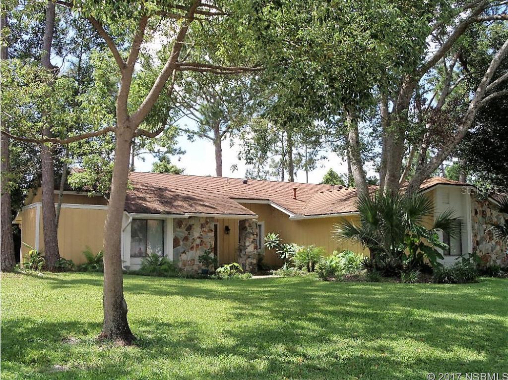 This Beautifully renovated home is located on a cul de sac in the prestigious Sugar Mill Country Club.  The home is situated on a small canal with a dock. The interior of the home has been updated with New Kitchen Cabinets, Granite Counter tops, Newer appliances, Fresh paint inside and out, new Carpet, all new light fixtures.  The Kitchen has a breakfast Bar, Large Porcelain Farm House sink and newer appliances.  The range is currently electric but there are existing gas lines should the new owner decide they prefer gas cooking. There is a nook for dining as well as a formal dining area.  Both baths have new vanities, light fixtures, faucets and mirrors.  The Living Room features two sky lights and a beautiful stone gas fireplace.  The Master Bedroom is spacious with a large walk in Shower, new Vanity, lighting and a walk in closet. Sliding Doors from the Master Bedroom lead out to a private outdoor sitting area. Both guest Bedrooms  are spacious in size and have plenty of closet space. The large Florida Room with heat and air is on the rear of the home and is perfect for a home office, TV room, sitting area, etc.  It leads out to an additional porch with glass windows and tile flooring. The inside Laundry room has two storage closets and a laundry sink. The back yard has a pavered patio with a walk way and gate leading to a dock on the canal.  Enjoy sitting on the dock taking in nature with a conservation area across the canal - so no back neighbors.  The side entry garage is over sized with a newer garage door.  The extra long driveway will easily accommodate 6 vehicles.  The Exterior has been freshly painted and landscaped.  There is a sprinkler system, Gas water Heater and gas hookup for dryer.  All of this located on a cul de sac in one of the nicest neighborhoods in New Smyrna Beach.  Close to Shopping, restaurants and all New Smyrna has to offer!!! ;Water: City