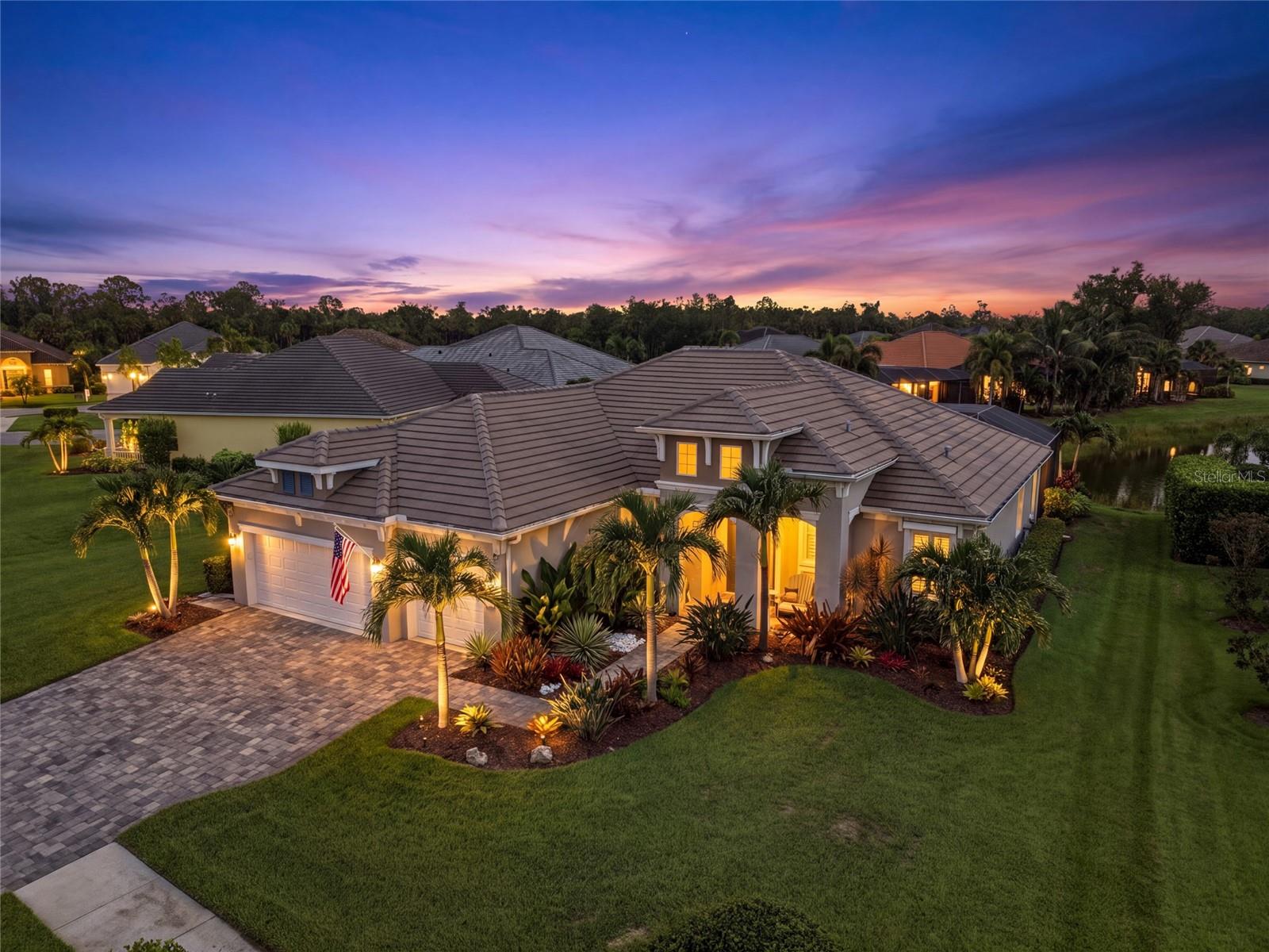 Virtually Staged. Situated on a premium water view homesite in Grand Palm at Wellen Park, this exceptional residence has been thoughtfully upgraded inside and out with high-end finishes, extensive storm protection, and resort-style outdoor living. The heated saltwater pool and Hot Springs® saltwater therapy spa overlook a peaceful pond, while the fully equipped outdoor kitchen, Nebula lanai accent lighting, and professionally designed landscape create the perfect setting for entertaining day or night.

Designed for both everyday living and effortless entertaining, the Sanibel is an airy, split-bedroom floor plan which offers 3 bedrooms, 3 baths, and a large private den that easily functions as a home office, media room, or guest space. The open-concept living area flows seamlessly into a well-appointed natural gas kitchen featuring abundant cabinetry, generous counter space, a center island, and a bright breakfast nook overlooking the pool and nature pond. 

Custom details elevate every space, including a dramatic great room ceiling, an electric fireplace, designer feature walls, plantation shutters, and personalized primary HIS and HER walk in closets. The three car, oversized garage is equally impressive with insulated doors, a split-system air conditioner, LED lighting, overhead storage racks, and a convenient pull-down attic for additional storage.

Built for comfort and peace of mind, the home is equipped with a 22kW Generac whole-house generator, hurricane-rated Storm Smart shades, aluminum roll-down shutters, an AquaCal electric pool heater, and numerous thoughtful upgrades throughout.

Beyond the home, Grand Palm offers an award-winning, amenity-rich lifestyle centered around its spectacular 32-acre Adventure Lake with kayak launches, fishing pier, and miles of nature trails. Residents also enjoy a state-of-the-art fitness center, resort-style pool, dedicated lap pool, pickleball and tennis courts, bocce, basketball, dog parks, playgrounds, and an active social calendar, all just minutes from Downtown Venice, Gulf beaches, and the vibrant shops and dining in Wellen Park.

This is a rare opportunity to own a spacious, upgraded water view home in one of Venice's premier, established resort-style communities. Offered for sale as partially furnished. List of furnishings available upon request. Listed tax amount includes low CDD but taxes may be lower or higher based on buyer exemption qualifications and sale price.