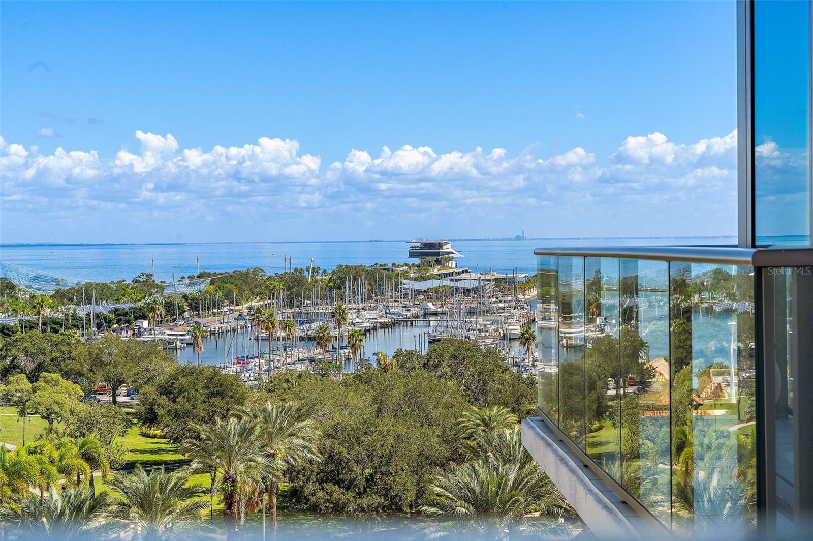 BEAUTIFUL and SPACIOUS WATER VIEW CORNER UNIT AT ONE ST. PETERSBURG! Step into a world of elegance as you enter this light-filled 3-bedroom, 3.5-bath + den corner residence. Every detail has been carefully curated to elevate your living experience. The 24" x 24" porcelain tile flooring flows seamlessly throughout, setting the stage for a space that exudes sophistication. The kitchen is the epitome of culinary excellence, featuring European cabinetry, top-of-the-line stainless steel appliances, marble slab backsplash, and hand-crafted Italian blown glass light fixtures that hang gracefully over the kitchen island. As you gaze out from the floor-to-ceiling glass windows, prepare to be mesmerized by unobstructed water and city views that envelop the north corner with spa like garden and pool views on back terrace. Three private terraces offer a retreat to soak in the breathtaking surroundings which include stunning sunrise views over the water to the east and sparkling sunset views over the city to the west. Inside, convenient electric blinds allow you to easily control the amount of light throughout the day with blackout shades in the owner and guest suites providing the ultimate in privacy and relaxation. Custom built-ins in the closets provide ample space to keep all your finest items organized and tucked away. With two extra wide protected parking spaces and a climate-controlled storage unit conveniently located on the 5th floor, your convenience and peace of mind are assured. This luxurious lifestyle extends beyond your residence. ONE St. Petersburg offers a wealth of amenities to elevate your everyday living. Only one flight down, walk to a 5,000 square foot free-standing fitness facility, a 75' heated lap pool with a soothing waterfall backdrop, 12 private cabanas, 2 inviting fire pits, and an outdoor kitchen with additional grills make for the ultimate outdoor oasis. Indulge in social gatherings in the formal social room with panoramic water views, try your hand at billiards in the game room, or seamlessly blend indoor and outdoor living in the club room that opens directly to the amenities deck. Plus, a 24/7 concierge service is at your beck and call. Situated in the heart of downtown, you're just steps away from over 40 restaurants, shopping, museums, theaters, galleries, and more, making this residence the perfect gateway to the vibrant urban life you've always dreamed of. Experience the epitome of luxury living at ONE St. Petersburg.