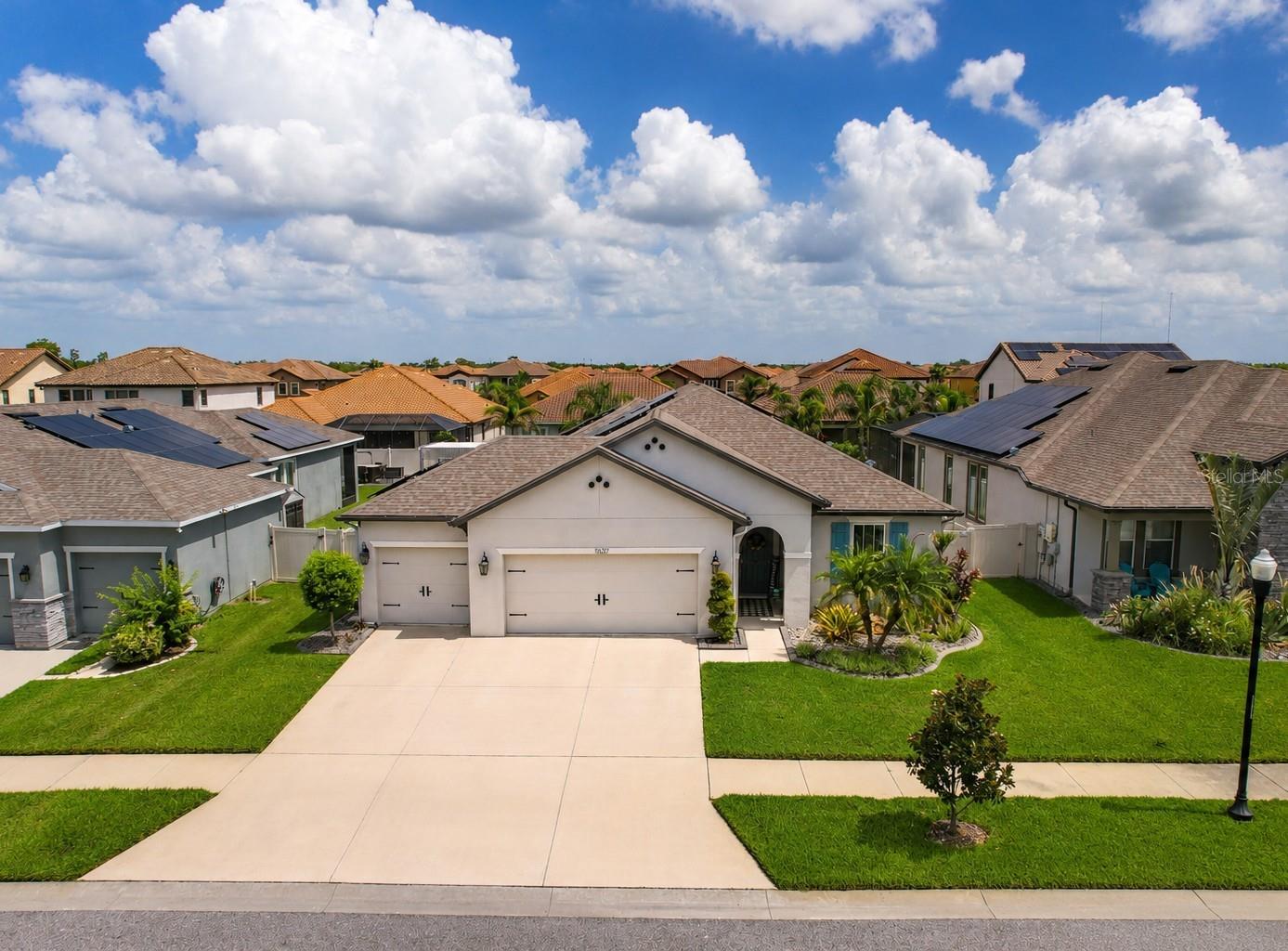 Welcome to 11637 Tetrafin Drive, where thoughtful upgrades, energy efficiency and true Florida living come together in The Reserve at Pradera. This beautifully maintained Beazer Homes Bayview features four bedrooms, two bathrooms, 2,228 square feet and an oversized three car garage, all set on a fully fenced homesite with a backyard that is noticeably larger and more private than most offered with this floor plan.

Inside, the open layout feels bright, comfortable and connected, with consistent wood look tile throughout the entire home, including the bedrooms, bathrooms and closets. Level 2 granite, 42 inch Tahoe cabinetry, oversized baseboards, crown molding and a raised 9 foot 4 inch great room ceiling give the home a polished, cohesive look. The Gourmet Supreme Kitchen was designed for buyers who truly enjoy cooking and entertaining, featuring KitchenAid appliances with a transferable extended warranty, double wall ovens, a cooktop, microwave, farmhouse sink, tile backsplash and a generous walk in pantry.

The spacious owner's suite offers a peaceful retreat with a walk in closet and a glamour bath featuring a soaking tub, seamless glass tiled shower and double granite vanity. A private laundry room, ceiling fans throughout, built in Guardian surround sound, smart home features and abundant storage make everyday living even easier.

Step outside and discover the space that truly separates this home from the competition. The extended covered and screened lanai opens to a heated pool with therapy jets, a sun shelf, bubbler, sheer descent waterfall and colored WiFi controlled lighting. Extended pavers, lanai fans and the expansive fenced backyard create the perfect setting for entertaining, relaxing or enjoying the Florida sunshine in complete privacy. A brand new pool pump with a transferable five year warranty and a new automatic pool cleaner provide additional peace of mind.

Forty six fully paid solar panels help reduce monthly utility expenses without the burden of a solar payment. Additional improvements include a Culligan water softener and reverse osmosis system, gutters, upgraded landscaping with concrete borders and rock beds, automated irrigation, flower bed misters and extensive garage storage that conveys with the home.

Residents of The Reserve at Pradera enjoy a resort style community pool, splash pad, dog park, playground, basketball court, soccer field, walking trails, neighborhood events and beautifully maintained outdoor spaces. The location offers easy access to I 75, US 301 and the Selmon Expressway, placing Downtown Tampa, MacDill Air Force Base, Tampa International Airport and Gulf Coast beaches within convenient reach. Publix, Sam's Club, shopping, dining, hospitals, golf courses, parks and everyday conveniences are all nearby.

With paid solar, an upgraded heated pool, an oversized three car garage, extensive builder upgrades and one of the larger private backyards available in this floor plan, this move in ready home offers the features buyers want without the time and expense of adding them later.