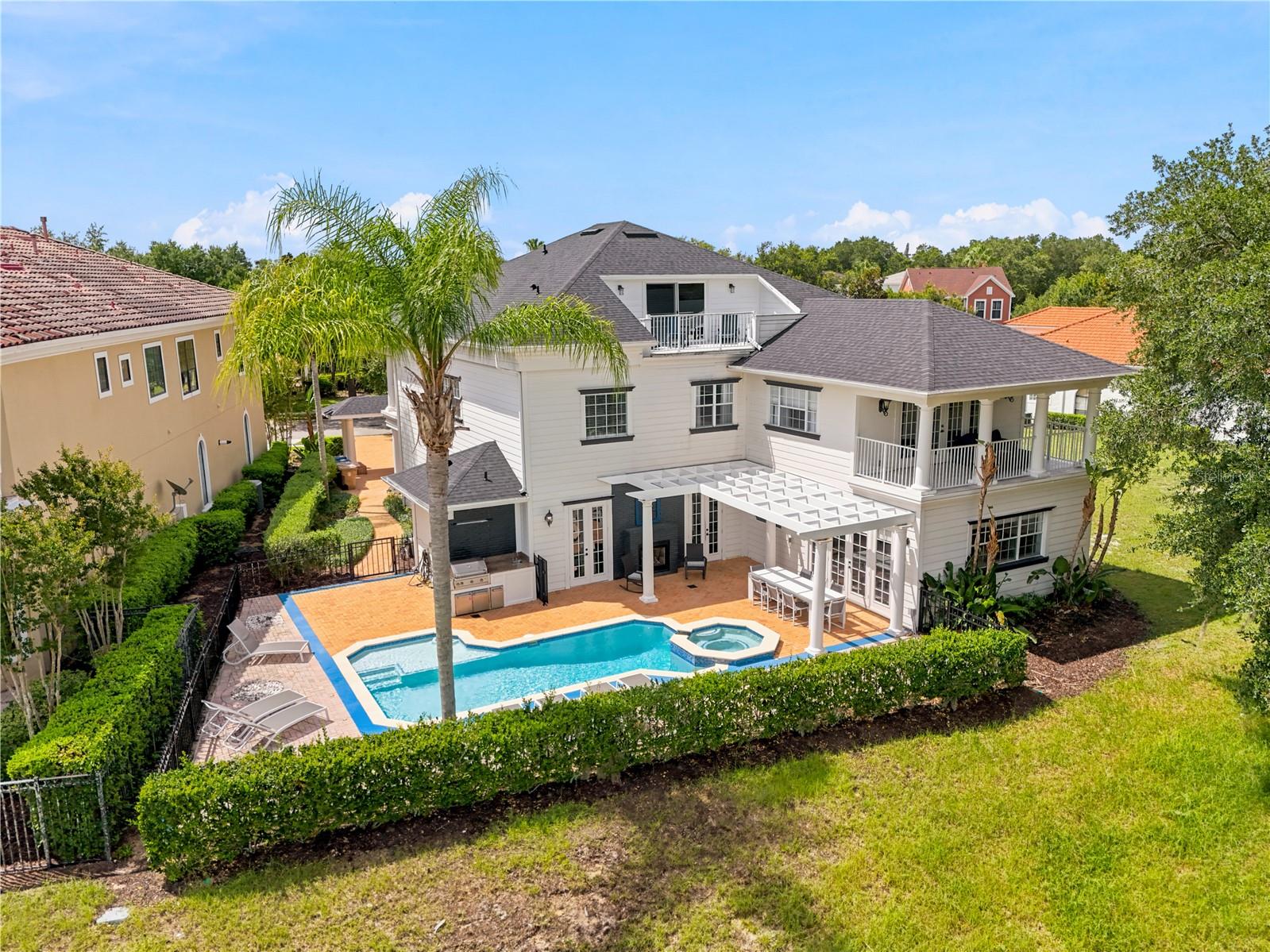 Ideally located on a PREMIER LOT within the award-winning REUNION RESORT, this luxurious GOLF FRONT ESTATE home overlooks the 2nd hole of the Tom Watson signature golf course. With an ACTIVE TRANSFERRABLE MEMBERSHIP and benefiting from a NEW ROOF (Oct 2025), this spectacular TURNKEY & FULLY FURNISHED home is set out over 3 floors which are serviced by a residential ELEVATOR. Perfect for entertaining family & guests, the VERSATILITY OF USAGE ranges from a primary residence, second/vacation home and/or high yield investment asset. With stunning curb appeal, the approach to the home immediately sets the scene of grandeur with its inviting covered front porch and double heighted entryway foyer. The floorplan flows effortlessly with its OPEN-PLAN CONCEPT living featuring a focal point gourmet kitchen with expansive island and stainless-steel appliances, separate dining space & expansive family room with multiple seating areas and gorgeous two-sided fireplace. The ensuite guest bedroom on the 1st floor has direct access to the patio/pool and there are two primary bedrooms with lounge areas & ensuite bathrooms situated on both the 2nd and 3rd floors. In addition there are two BESPOKE THEMED bedrooms – a magical Harry Potter bedroom which sleeps 10 and a seaside beach inspired bedroom which sleeps 8 together with a stunning hidden immersive undersea hideaway gaming/playroom. The property boasts abundant spaces for both relaxation as well as ample ENTERTAINMENT AREAS including a dedicated themed arcade room as well as pool, card and games tables. Seamlessly blending the indoor with the outdoor and further complementing the home, there is access to multiple PRIVATE BALCONIES to avail of the early morning sunrises or evening sunsets. Enjoy outdoor Florida lifestyle at its finest sitting out on the large patio OASIS area soaking up the sunrays, swimming in the pool or lounging in the spa. Cook on the outdoor grill and dine poolside whilst admiring the backdrop of the unbeatable PANORAMIC VIEWS overlooking both the pool area as well as the stunning sweeping views of the fairway. Reunion Resort features three world class golf courses (designed by Arnold Palmer, Tom Watson & Jack Nicklaus), a golf academy, Clubhouse at The Bear’s Den, six onsite restaurants, twelve community swimming pools, a multimillion-dollar water park, Har-True tennis courts, pickleball, bocce ball, volleyball, crazy golf, a playground, full-service salon and spa. Reunion is conveniently located a couple of miles away from Walt Disney World Resort, Seaworld and Universal Studios. Video as well as 3D virtual tour & floorplan available! DON’T MISS OUT, schedule your showing today!