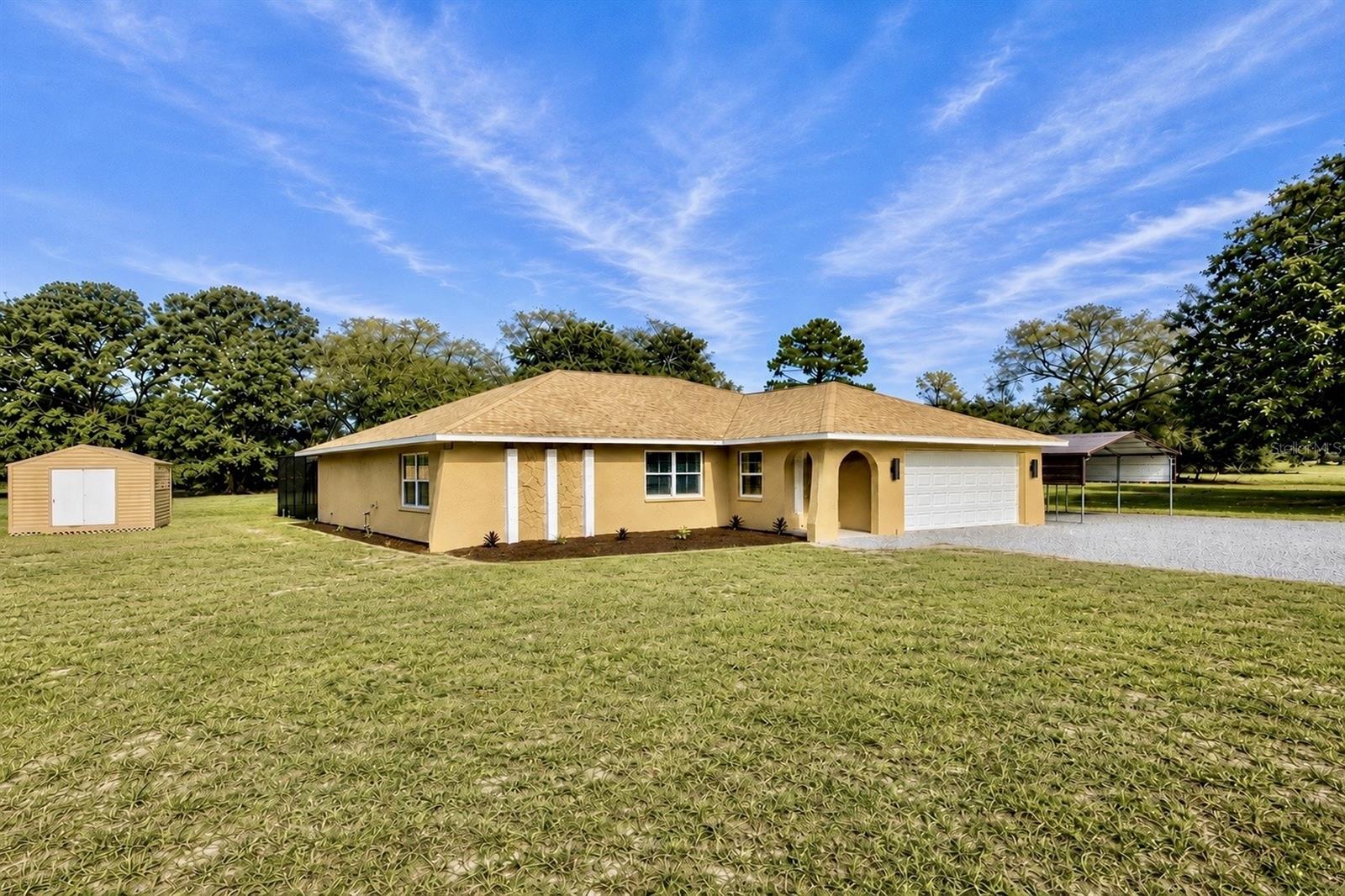 Welcome to a truly one of a kind custom renovation situated on 2.5 fully fenced acres. This completely reimagined open floor plan home was thoughtfully designed and showcases a level of craftsmanship and finish quality rarely found in today’s market. From the moment you enter, you’ll notice the custom finishes, upgraded materials, and attention to detail throughout. The home features large format 24x24 ceramic tile throughout, custom wood cabinetry, premium quartz countertops, designer lighting, custom millwork, and carefully selected high end finishes in every room. The kitchen was designed to impress with a massive island, farmhouse sink, custom all wood cabinetry, built in microwave, premium vent hood, and an oversized 36 inch range. The open concept design flows seamlessly into the spacious living and dining areas beneath soaring ceilings, creating the perfect space for entertaining and everyday living. The owner’s suite features custom California Closets and a beautifully designed spa inspired bathroom complete with dual vanities, custom cabinetry, oversized walk in shower, designer tile work, and premium fixtures. Outside, the property offers the privacy and flexibility that acreage buyers are searching for. The entire 2.5 acre parcel is fully fenced and includes a huge storage shed, covered carport, swimming pool, and ample room for recreational vehicles, boats, equipment, pets, or future additions. Every major component of this home has been thoughtfully renovated with quality and longevity in mind.