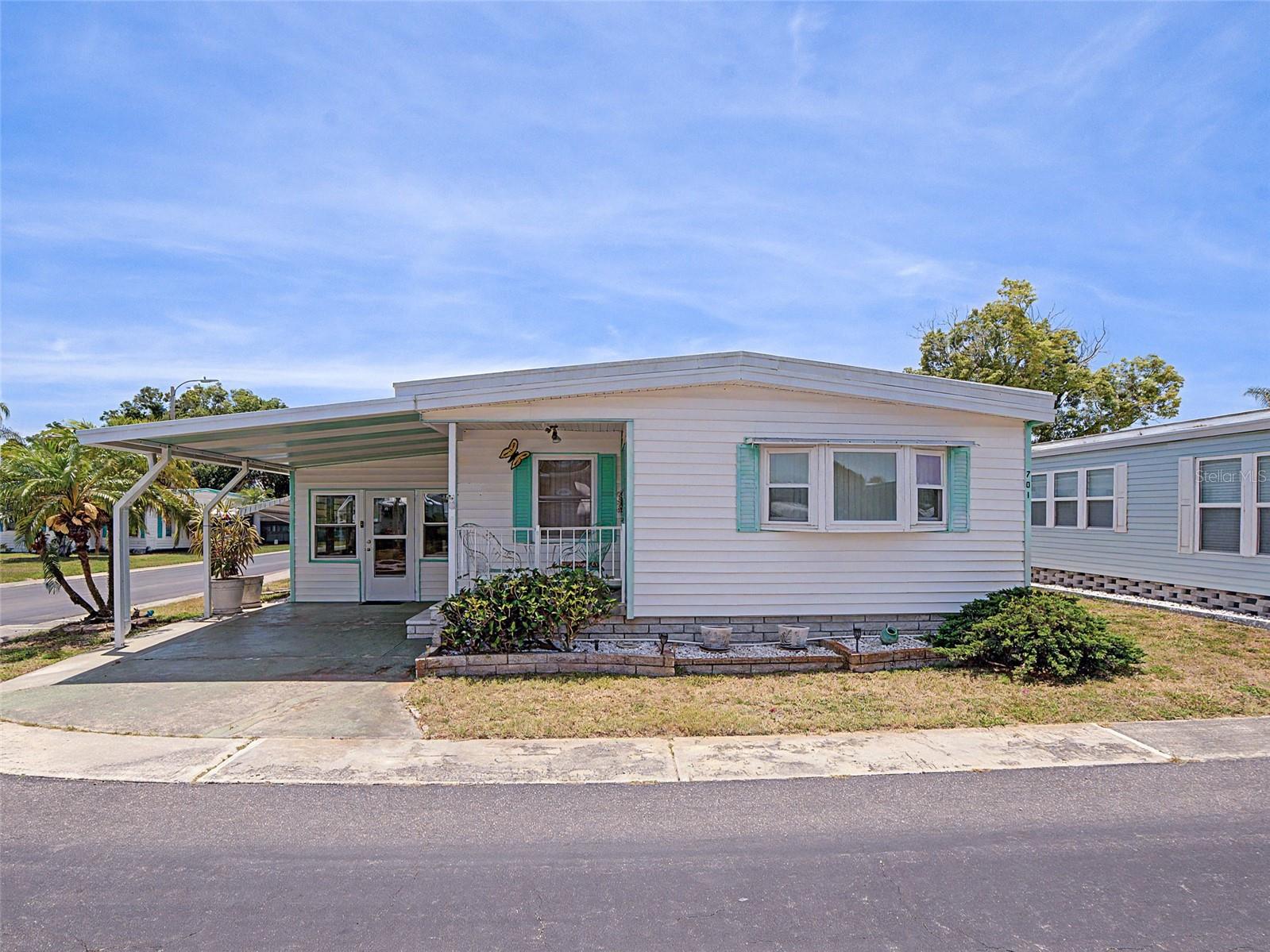 Welcome to 701 Sugar Palm Street located in the highly sought-after 55+ community of Palm Hill Country Club in the heart of Largo! This spacious 2-bedroom, 2-bath manufactured home offers approximately 1,000 square feet of comfortable living space along with a Florida room and covered carport, creating the perfect setup for year-round Florida living.

Inside, you’ll find a bright and functional layout with generous living and dining areas, spacious bedrooms, and additional flex space in the Florida room ideal for relaxing, entertaining guests, or enjoying your morning coffee. The covered carport provides convenient parking and additional storage potential.

Life in Palm Hill Country Club feels like living at a resort. Residents enjoy access to an impressive lineup of amenities including a 9-hole golf course with optional memberships and pay-to-play opportunities, 2 swimming pools and jacuzzi's, pickleball and tennis courts, shuffleboard, bocce ball, billiards, horseshoe pits, two clubhouses, libraries, social events, clubs, dances, and endless activities for an active lifestyle.

Conveniently located just minutes from the beautiful Gulf beaches, the Pinellas Trail, shopping, restaurants, medical facilities, and nearby airports, this community offers the perfect blend of relaxation and accessibility.

Whether you’re looking for a full-time residence, seasonal getaway, or low-maintenance Florida retreat, this home is a fantastic opportunity to enjoy all that Palm Hill Country Club has to offer!  This is a Cash Only sale.