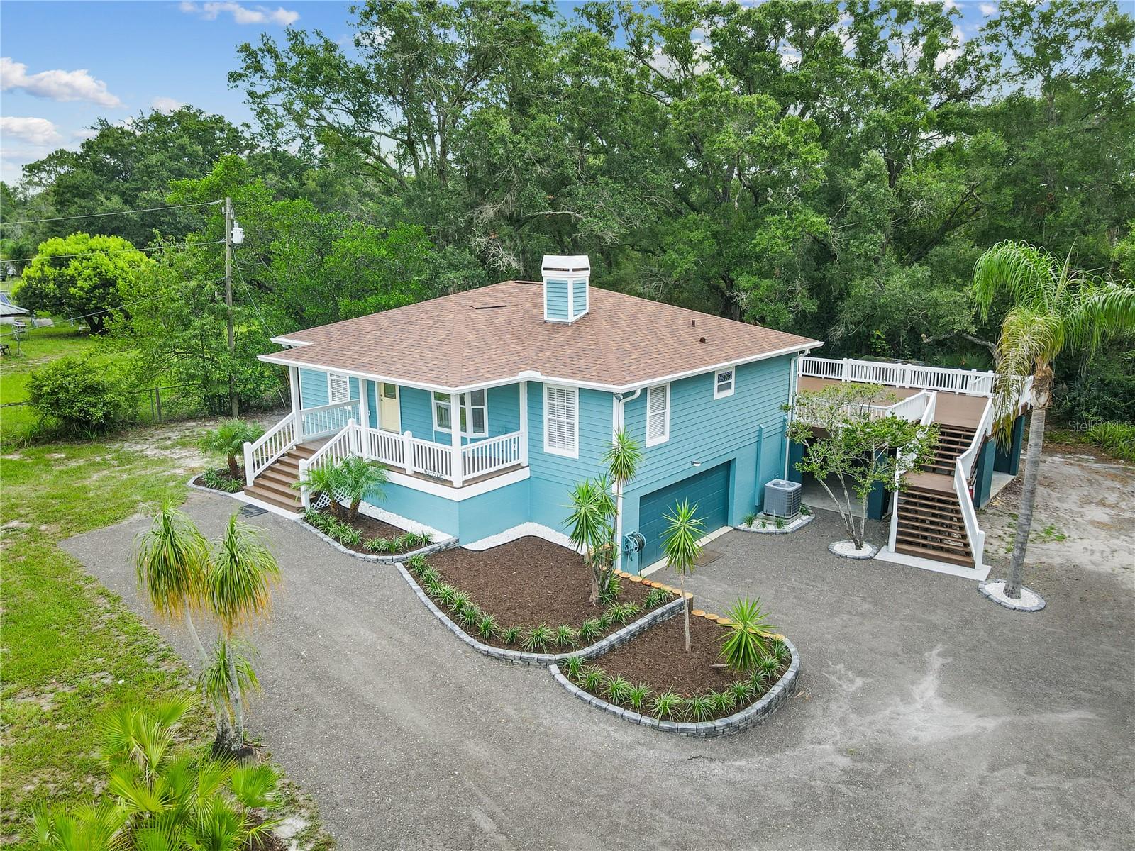 A True Hideaway! Country Living with Room to Breathe | No HOA | No CDD | Agricultural Zoning!! Welcome to 2650 20 Mile Level Road, a rare opportunity to enjoy the freedom of true country living in the heart of Land O' Lakes. Situated on 2.00  fenced acres with Agricultural zoning, this move-in-ready property offers the space, privacy, and flexibility that are becoming increasingly difficult to find in today's market. Bring your horses, goats, sheep, chickens, and other farm animals while enjoying the freedom to park your RV, boat, work trailers, and recreational vehicles right on your own property. This property offers a lifestyle many buyers dream about but rarely find. Built in 1988, this custom 4-bedroom, 2-bathroom home combines modern construction with the charm and functionality of country living. Inside, you'll find  an open-concept layout that creates a bright and spacious atmosphere. The kitchen serves as the heart of the home, It features white cabinetry, upgraded granite countertops, a large island, stainless steel appliances, and a breakfast nook. There’s also. The spacious master bedroom includes a walk-in closet, separate vanity, and  Bedrooms 2 and 3 are generously sized with an additional walk-in closet Wood floors features include an indoor laundry room with washer and dryer, a two-car garage, and a large garage for extra storage or future build-out. Major upgrades: Exterior and interior Sherwin Williams paint The garage conversion offers versatile bonus space ideal for a home office, fourth bedroom, fitness room, or hobby space. New roof (2026), Garage door  (2026),   features mature trees and palms, offering tranquil views of wildlife with no back neighbors and exceptional privacy in a peaceful, established community.  The backyard includes a 600 Squar Feet Mult level wooden Deck with ample lounging space restored and Newley painted. Brand New Roof in June 2026. New paint inside and out 2026. , the home offers an airy open concept with  abundant natural light.ng! ,One or more photos have been virtually staged.  Located in a quiet and friendly neighborhood near a horse stable that offers riding lessons, you'll enjoy the tranquility of country living while remaining conveniently close to SR 41, SR 52, SR 54, I-75, and the Suncoast Parkway. Shopping, dining, medical facilities, and highly rated schools are all within easy reach. Properties like this are becoming increasingly rare. If you've been searching for acreage, agricultural zoning, a newer home, room for animals, RV and boat parking, Give us a call
