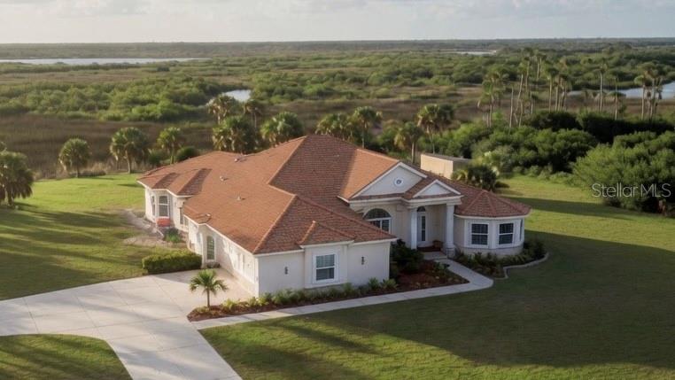 Viewing by Appointment only.

This is rare opportunity to own a lakefront home in the gated Lake Geraldine Community, on 3 acres with the Myakka State Forest behind for privacy and Wellen Park just over a mile away for shopping, dining and entertainment, including the Atlanta Braves Spring Training Field. Englewood Beach is less than 20 minutes and Venice Beach 30 minutes away. A new tile roof will be completed on 4/21. New landscape on the front and SE side is watered by drip irrigation.
 
This spacious Mediterranean style luxury home has 3969 SF of conditioned space, high ceilings including vaulted and tray ceilings and crown moldings, wide hallways and porcelain tiles  throughout the living areas. Walking in the front door you enter a large foyer with views of the formal dining and formal living rooms and the pool deck to the back yard view. There are 4 Bedrooms, 3 full and 1 half baths, and a 3-car garage. The large Master Suite includes a sitting area and wood floors, the bathroom has porcelain tile, a walk-in shower with bench, jetted soaking tub, separate vanities, and two walk-in closets with wood floors. The bathroom opens through double doors  to the 16' x 11.5' library with built-in shelving and a reading area with large windows, double doors from the foyer and to the adjoining office- with wood floor and built-in desk and cabinetry and a bay window looking out over the 30-acre lake. The Master Suite bedroom has a door to the pool and an entry hall with a door opening to the formal living room with gas fireplace, built-in cabinetry and shelving. A second Master/ Guest Bedroom includes a sitting area, breakfast bar with new refrigerator, and walk-in shower. The additional two bedrooms share a bath. Bedroom 4 has pool access. The laundry room  with built in cabinetry and the half bath are next to the garage,.

The dining room has a built-in serving cabinet, adjacent butler's pantry and a wine bar/ cooler, opening to the 18' x 14' family room, with built-in cabinetry for a wide screen TV, and the kitchen. The kitchen includes granite counters, high- end appliances, a breakfast nook, and a pass-through window behind the sink to the patio table area. The built-in family desk is off the kitchen. The rear patio contains a screened-in heated private pool and spa and room for a covered dining table, overlooking the rear yard and State preserve. The pool pump equipment is new, pool has in-floor cleaning system. House water is from a well and new whole- house reverse-osmosis system.