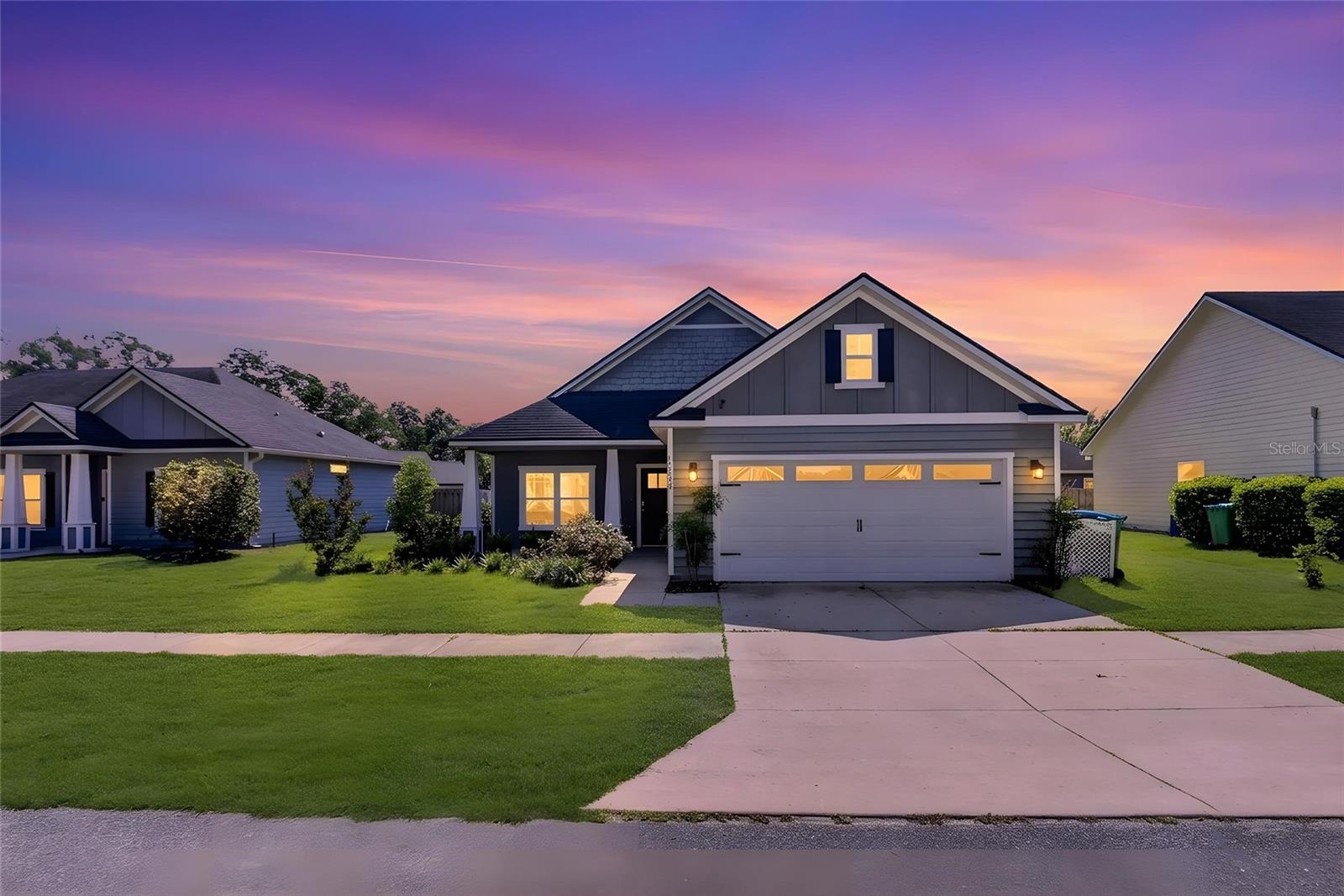 Welcome to this beautifully designed 3-bedroom, 2-bathroom home in High Springs, offering an inviting open-concept layout that greets you the moment you walk in. The spacious master suite stretches across the back of the home and features a serene retreat with dual sinks, a large soaking tub, walk-in shower, oversized walk-in closet, and a private water closet. The kitchen and bathrooms are finished with granite countertops, while upgraded touches throughout include luxury vinyl flooring, soft-close cabinets, stainless steel Whirlpool appliances, stylish accent walls, and upgraded tile flooring in the baths. Thoughtful details such as extra storage, a laundry room,  tankless water heater, and a Rain Bird irrigation system add comfort and convenience. Located on the community’s only one-way street, this property offers the added benefit of reduced traffic, making it a peaceful place to call home.