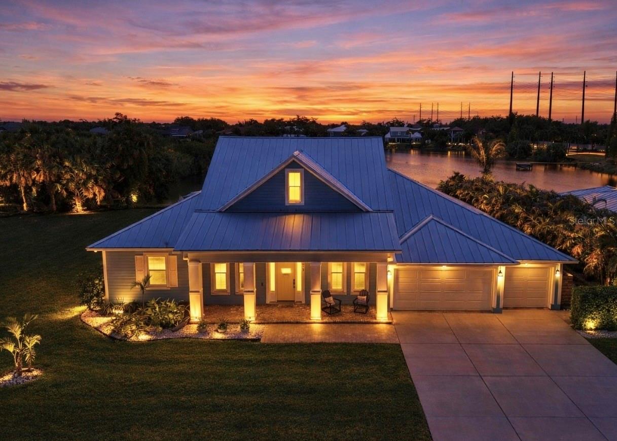 Welcome to your personal paradise where the allure of waterfront living meets high-end luxury and NO FLOOD INSURANCE required. A rare opportunity to live in a Key West inspired private community of Key West Landings on the Alafia River off of Tampa Bay. This gated oasis of only 18 homes, with DEEDED BOAT SLIPS offers a lifestyle that dreams are made of. Imagine stepping into a world where palm trees sway gently in the breeze, surrounded by mature landscape with grand oaks and the tranquil waters of the Alafia River invite you to explore.

This stunning executive home boasts a coveted boat slip with lift, setting the stage for sunset cruises and boating adventures. The Alafia River offers a unique Old Florida charm with several water front restaurants. Only minutes to Tampa Bay with the contrast of skyline views, sandy beach islands and all the excitement of the Riverwalk. This is a true boaters paradise.

Nature is calling, unwind on this oversized lot with views of a private 4 acre lake stocked and ready for bass fishing. Bird lovers will enjoy the endless variety and your own aviary off of the lanai.

The heart of the home is the expansive living room, where French doors open to reveal an enormous pavered lanai. The centerpiece is a resort style pool, outdoor living with al fresco dinning, and a dream outdoor kitchen. Imagine gatherings around the 4-foot-wide fireplace, under the stars, creating memories that last a lifetime.

Walk through the grand entrance to discover a haven of comfort and style. The downstairs primary suite is a sanctuary with two walk-in closets and a spa inspired bath featuring separate double vanities, a frameless glass shower, and a sleek freestanding tub. A second primary or guest suite, study, and laundry room complete this level, ensuring convenience and privacy.

Upstairs, two more bedrooms sharing a jack and jill bath and an oversized loft offer space for family and guests. Throughout the home, 10-foot ceilings and 8-foot doors create an airy, open feel. The kitchen is a chef's delight with quartz counters, Thermador and Bosch appliances, and 42-inch maple cabinetry.

This home is equipped with high end upgrades, from the exterior Hardie board siding, metal roof, Low E double pane hurricane impact windows, a full-house water filtration system, and an invisible dog fence. Recent updates ensure peace of mind, with a new pool screen, freshly resealed pool tiles, and a new pool heater and air conditioning system.

In this idyllic waterfront community, every day feels like a vacation. Step into a life where elegance meets adventure, and tranquility is part of your everyday routine.

Seize this opportunity to own a piece of paradise. Your dream home awaits.